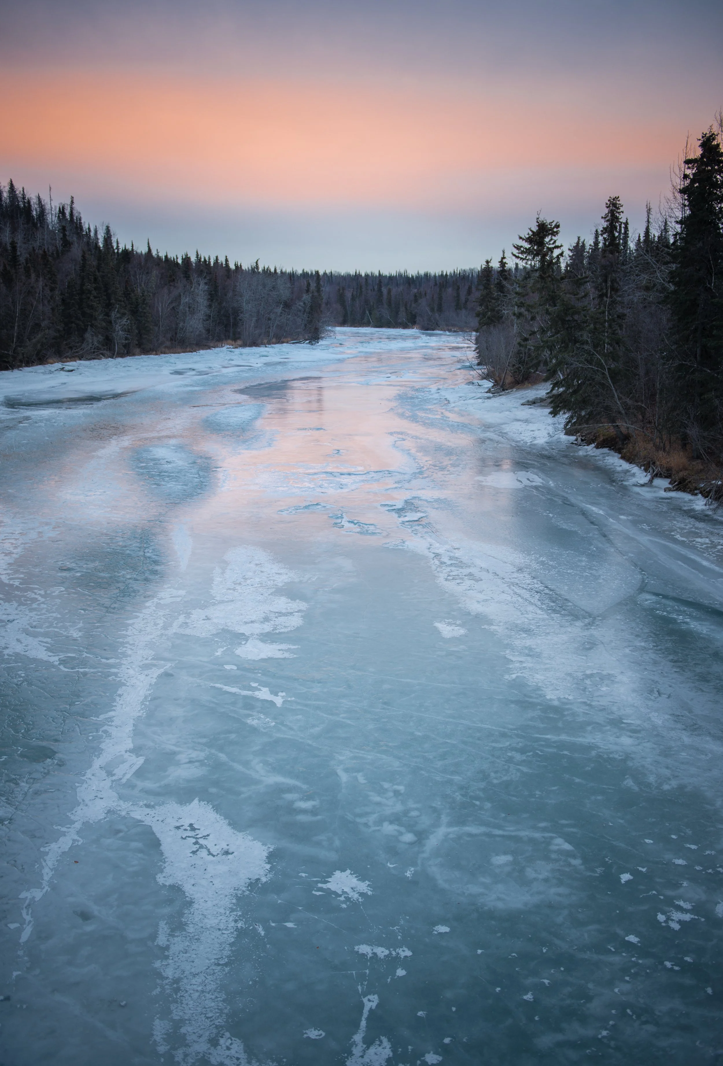 frozen river in alaska at sunset