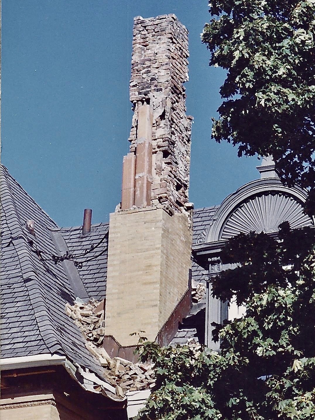 Lightning Strikes, Brick by Brick Rebuilt

This historic chimney was severely damaged&mdash;likely by a lightning strike&mdash;leaving the upper section collapsed and scattered across the slate roof below.

The second photo shows the result of a full