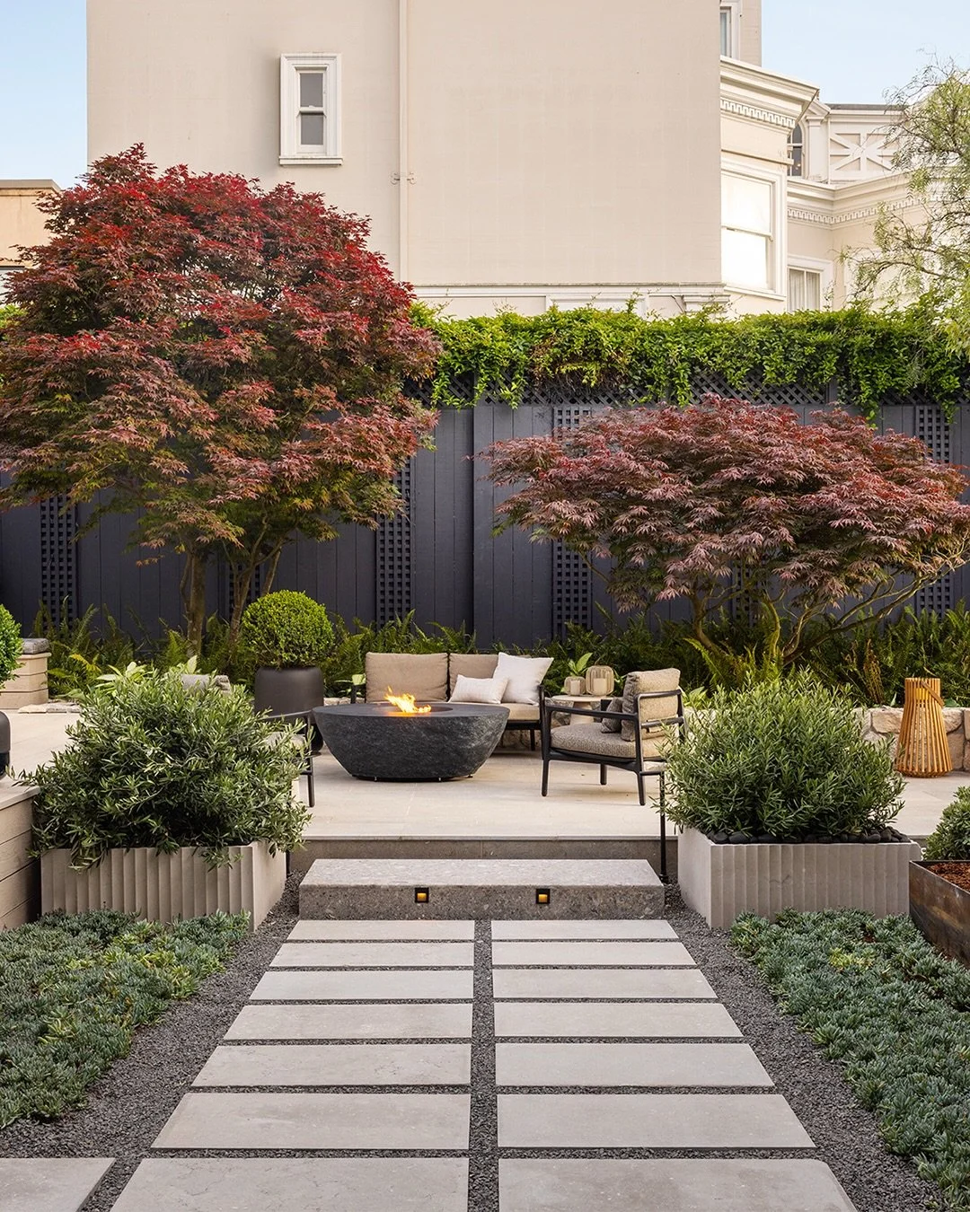The Rear Garden by @martinellidesign with @youngandburton

The space was inspired by the Year of the Fire Horse, providing calm, retraint, and quiet continuity. A palette of neutral earth toned browns, black, white, blues and greens allows texture an