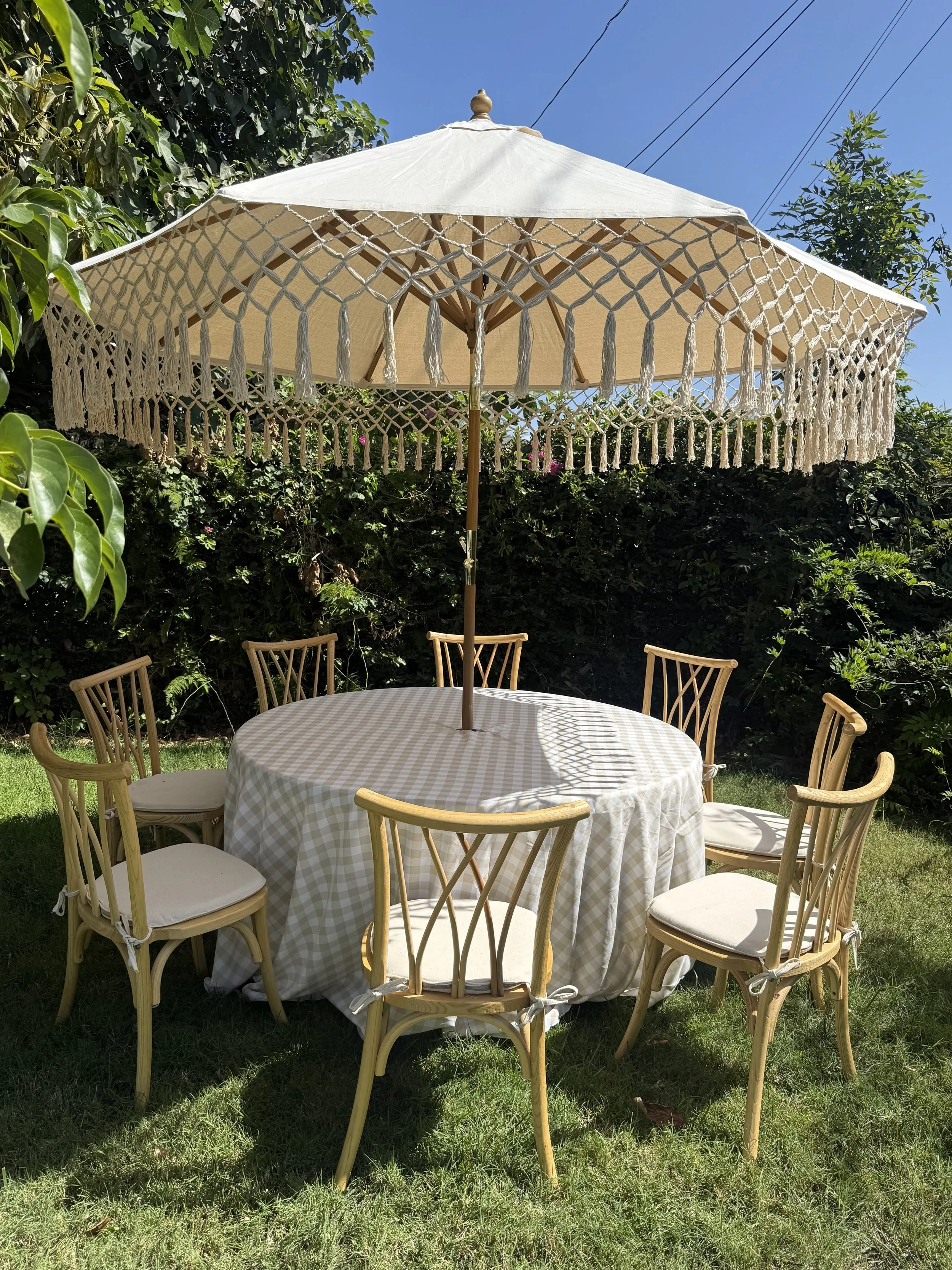 Fringe Umbrella Table Set with Natural Wooden Willow Chairs Rental | Event Rentals