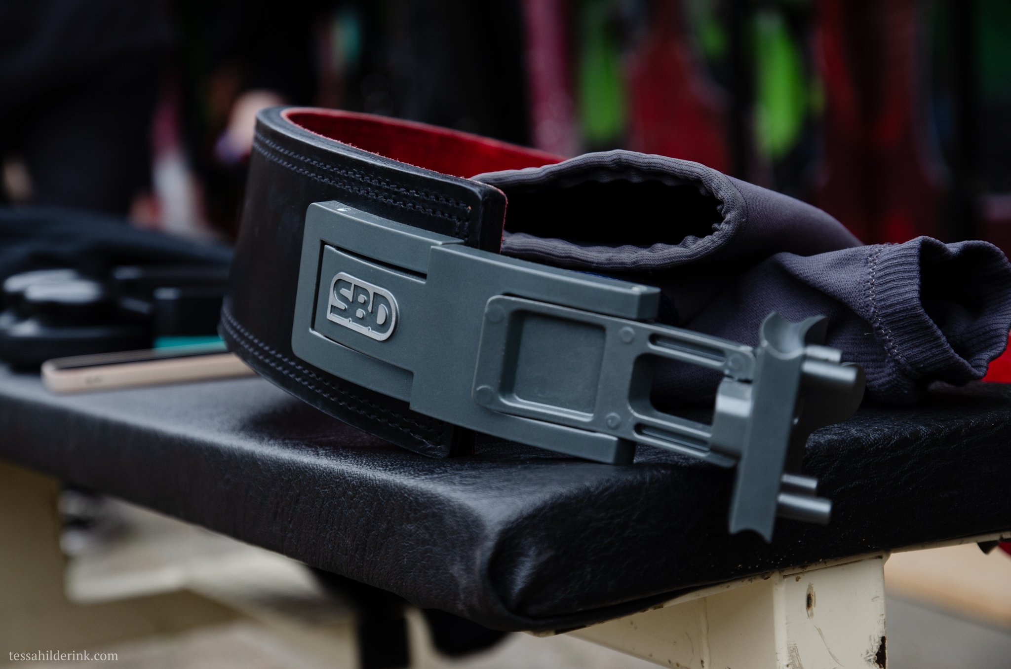Powerlifting belt and lifting gear on a bench