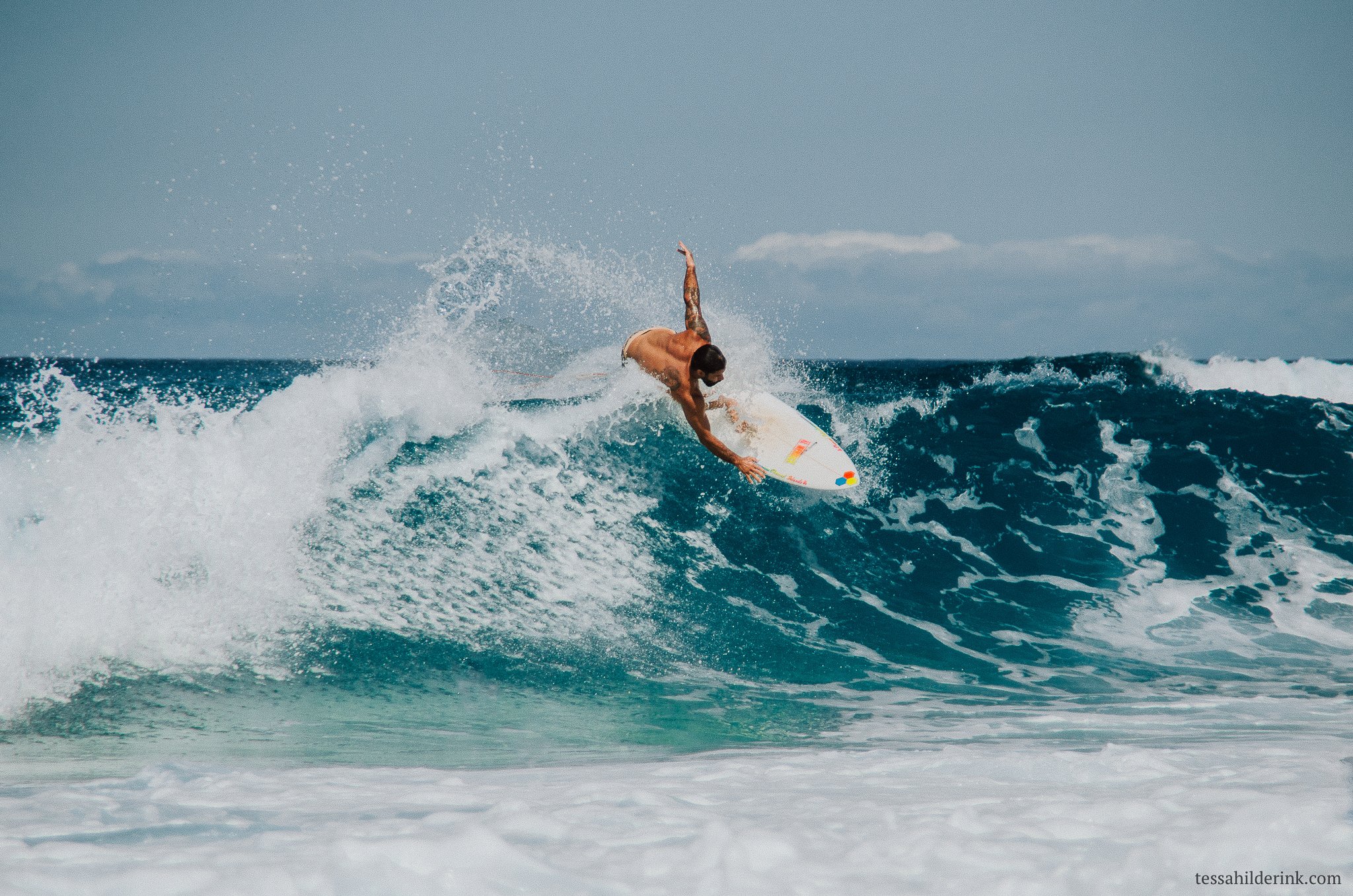 Surfer performing a maneuver on a wave
