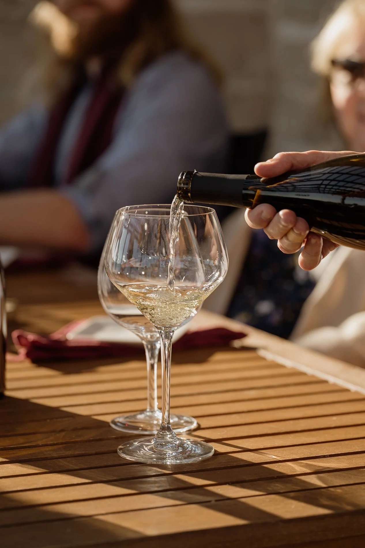 white wine being poured into a glass
