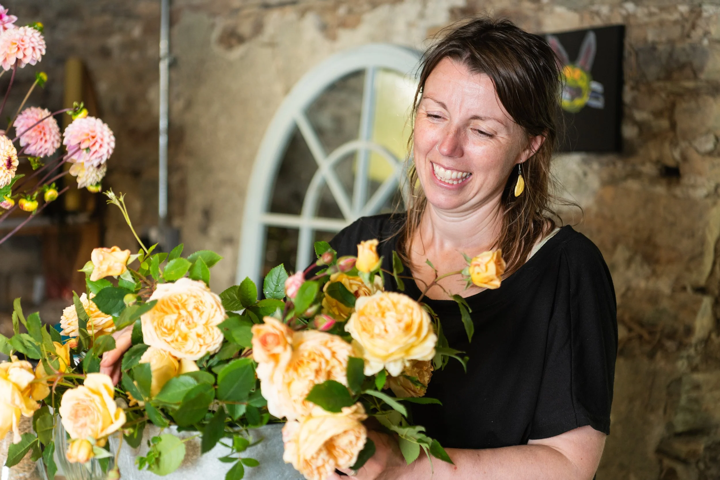 Flicky Howe inspecting freshly picked garden roses. Image by Anna Groniecka Photography