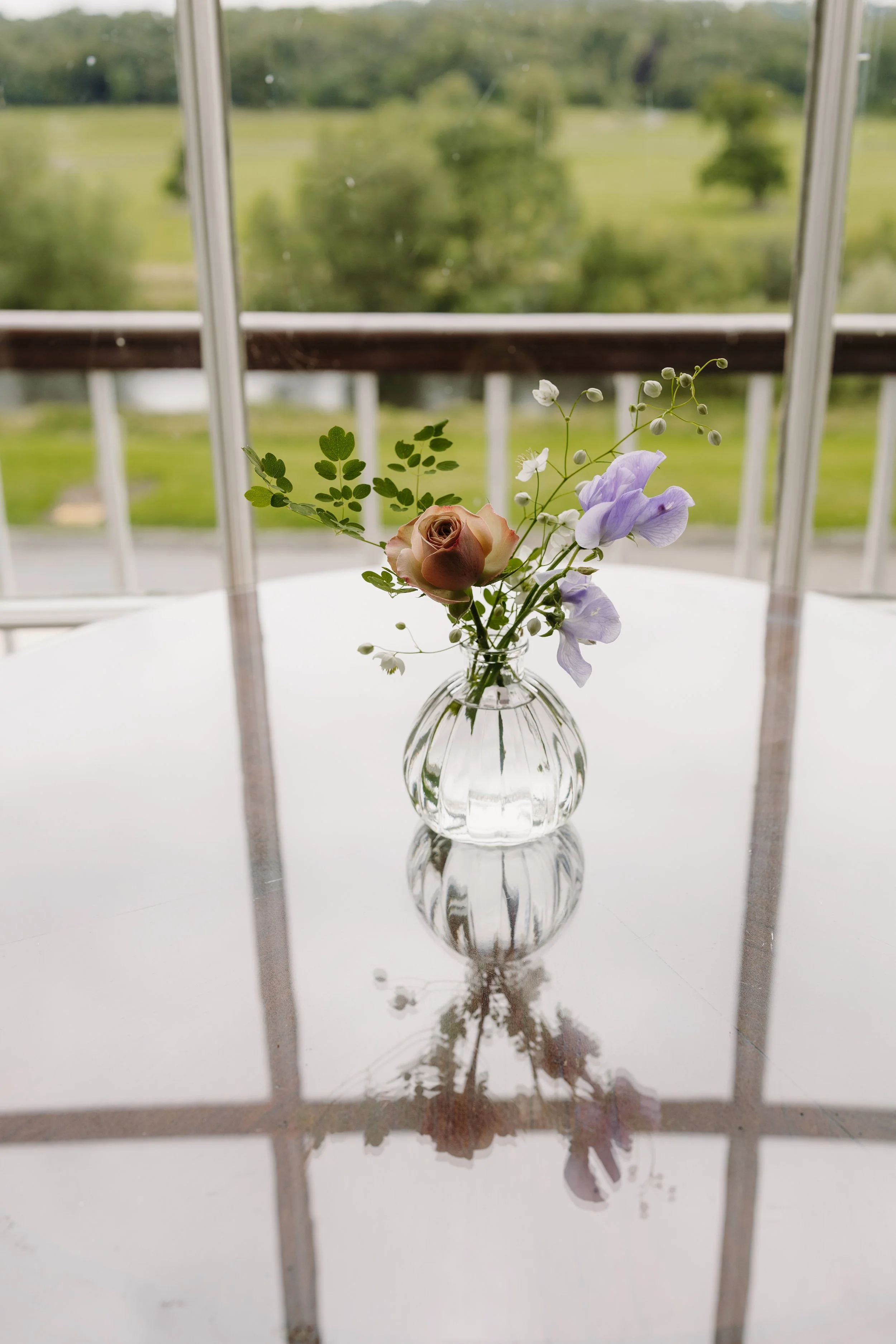 Bud vase of delicate garden flowers in the window of Mount Juliet estate. Image by Elaine Barker Photography