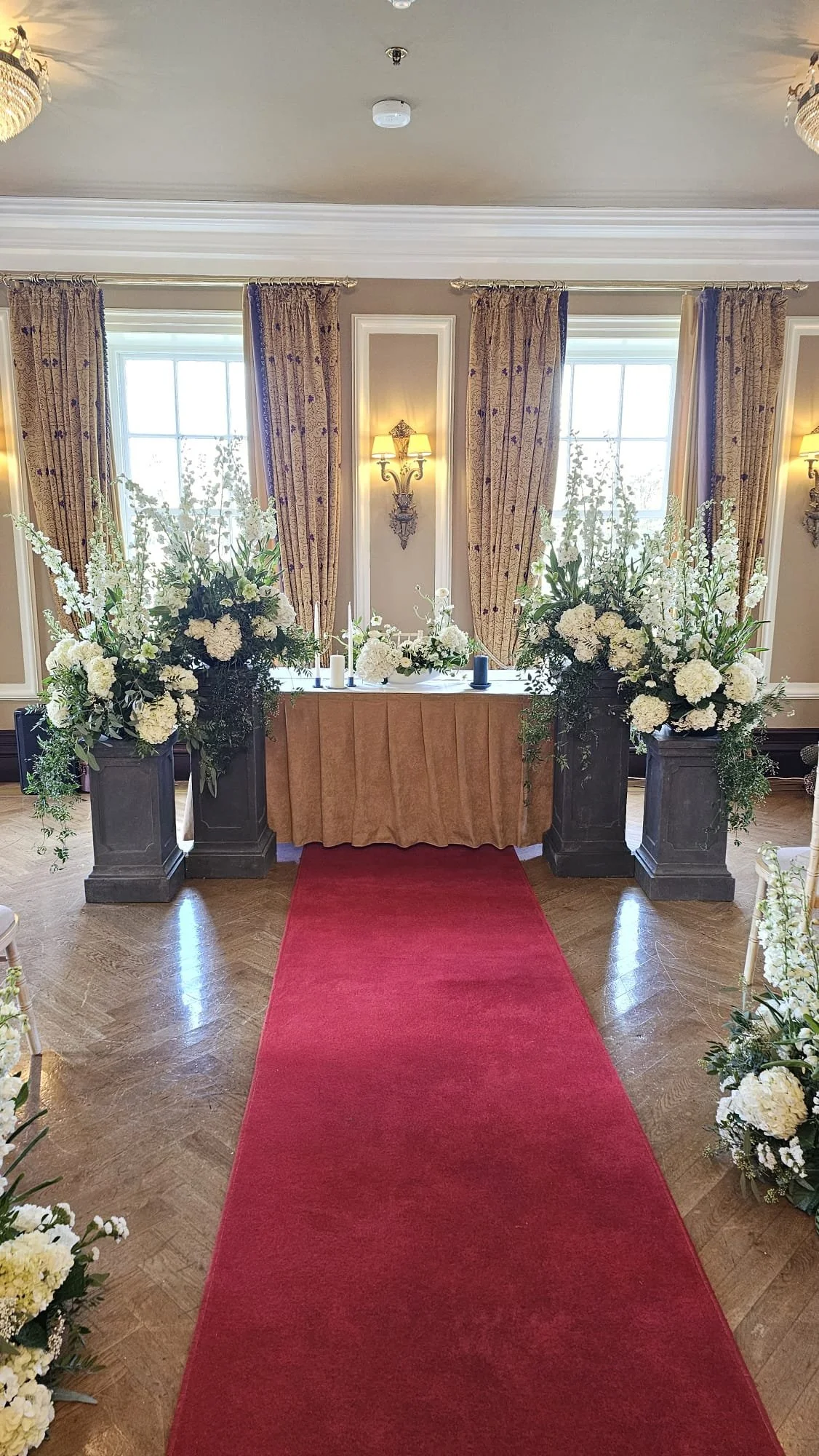 The ceremony flowers set up in The Kiltha Room, Castlemartyr Estate