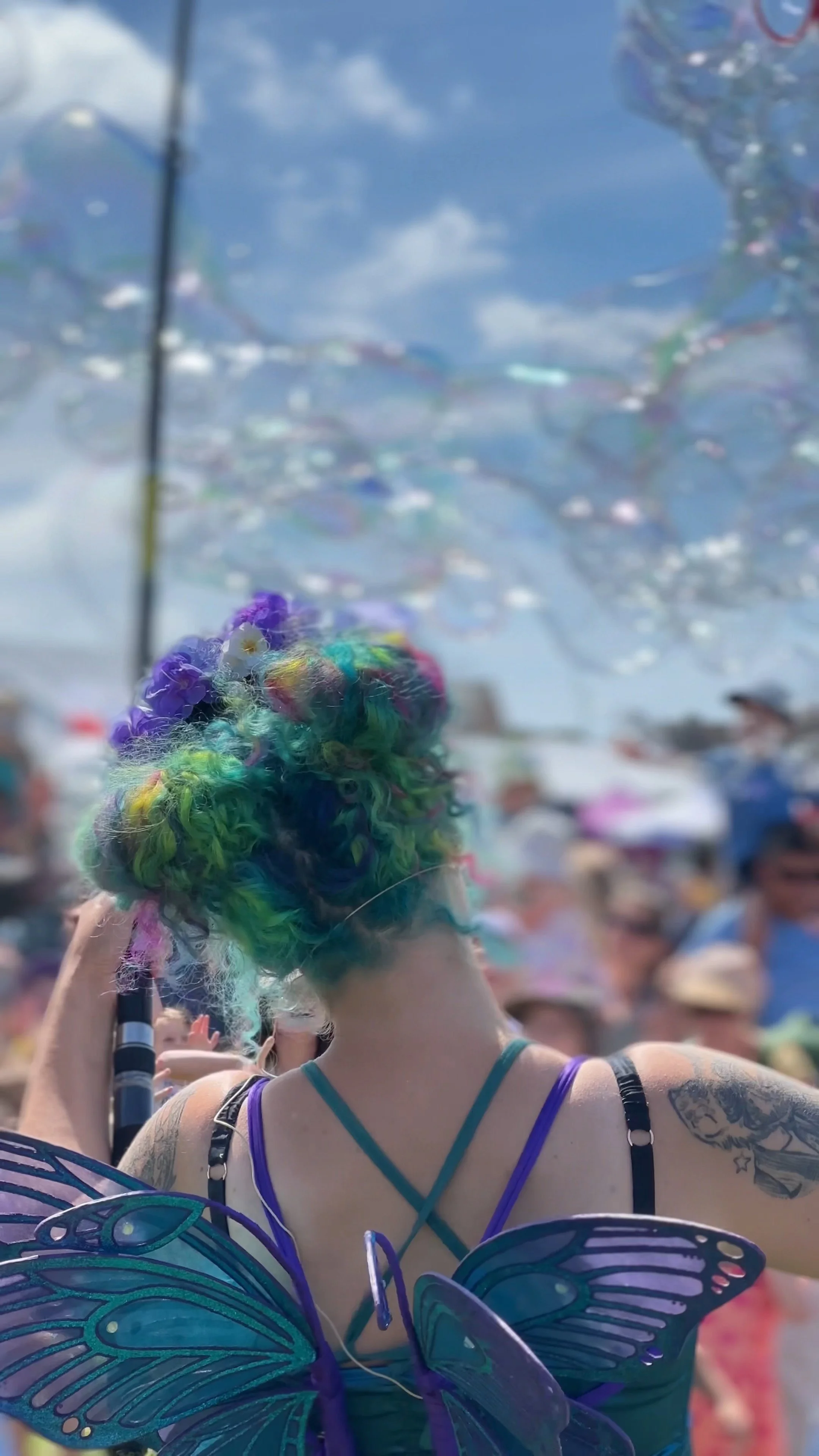 Bubble fairy creating lots of bubbles to crowd