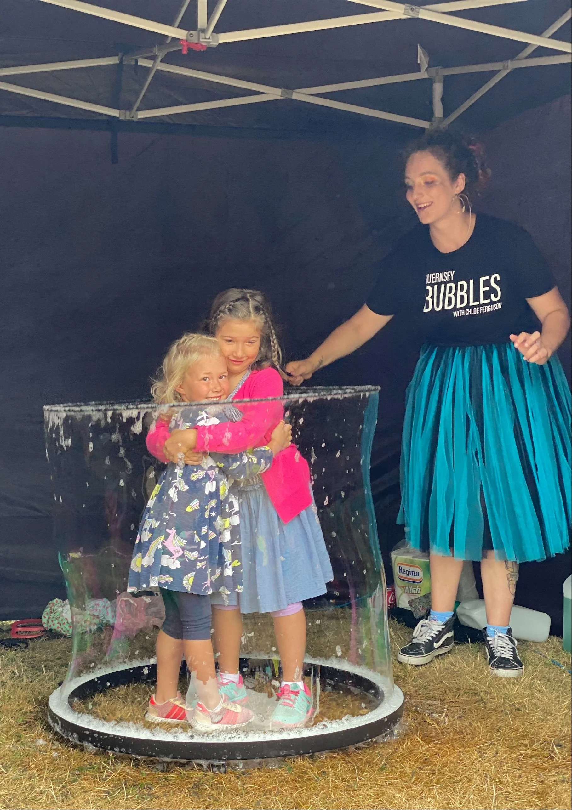 Children inside of a bubble in a gazebo