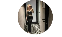 Woman taking a mirror selfie in a fitting room
