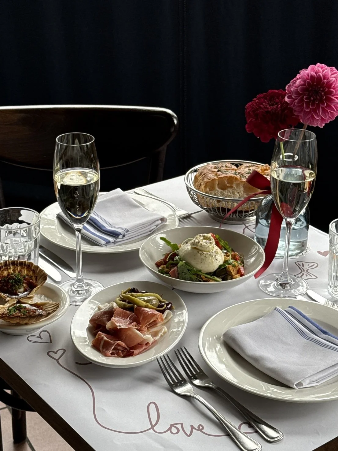 FIOR Valentine's day table setting with a whole burrata, and drinks