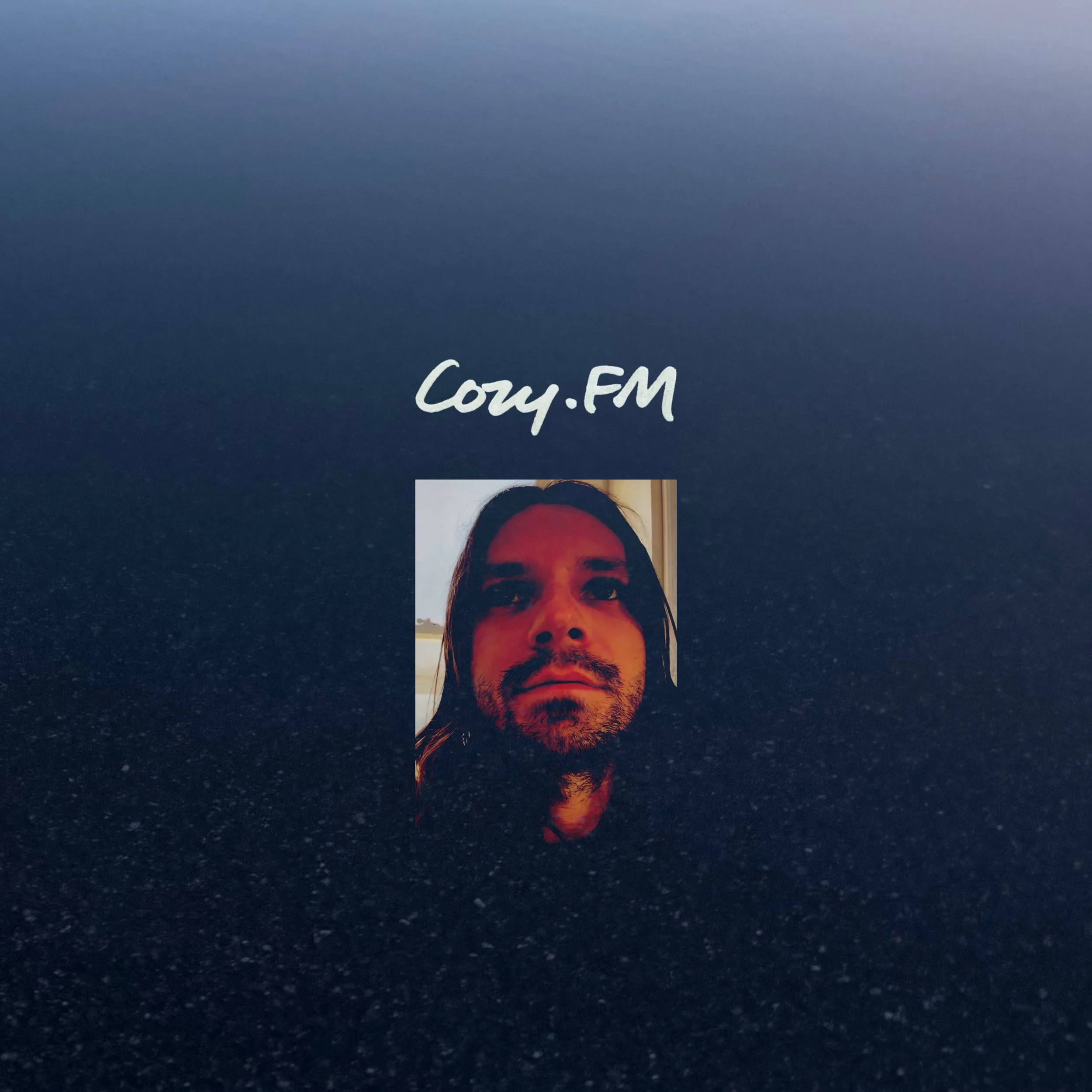 Cover for podcast Cozy.FM a cool blue background with white text Cozy.FM with Cozy's face below