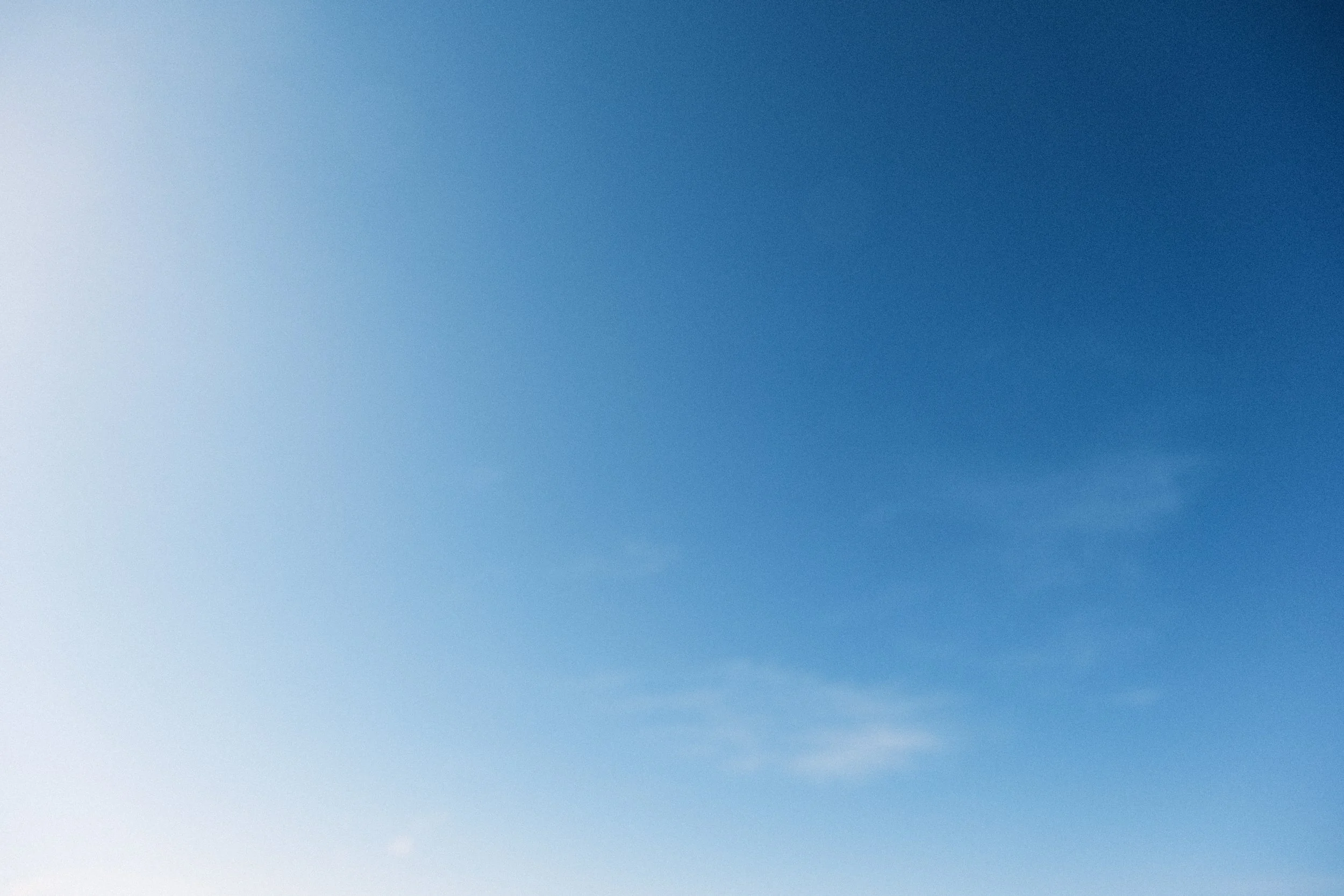 Clear blue sky with few wispy clouds.