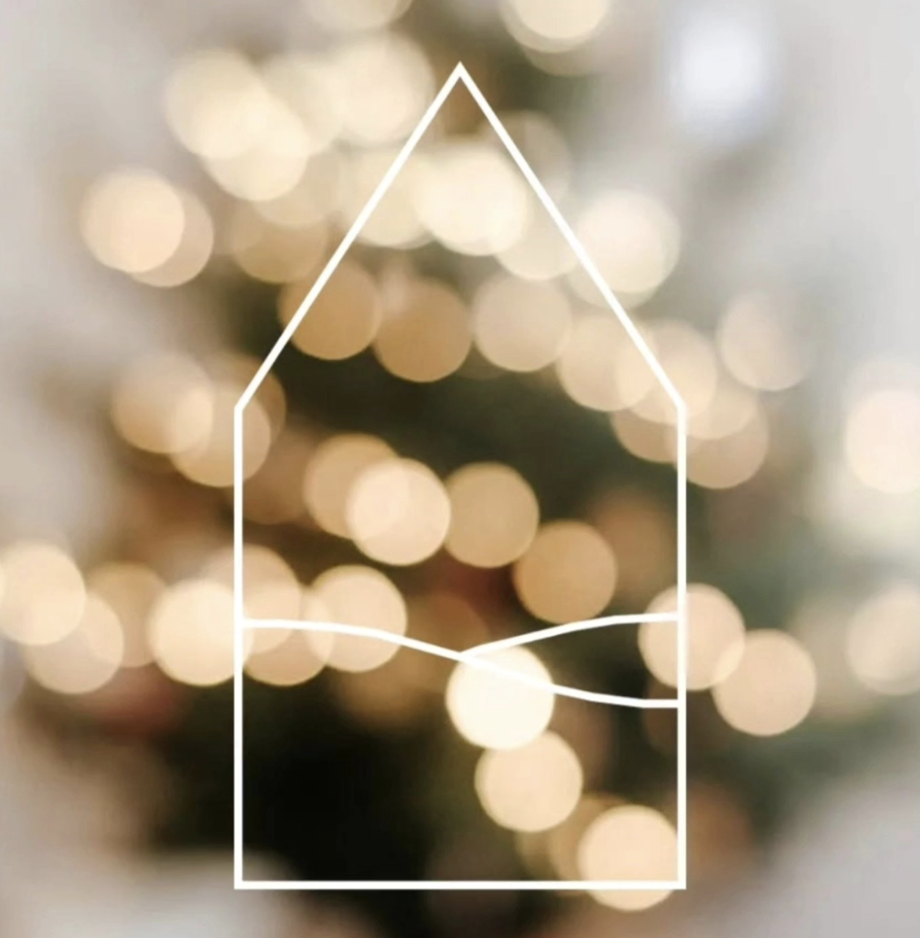 Blurred image of a decorated Christmas tree with warm lights, overlaid with an outline of a house shape, also drawn with a white line.