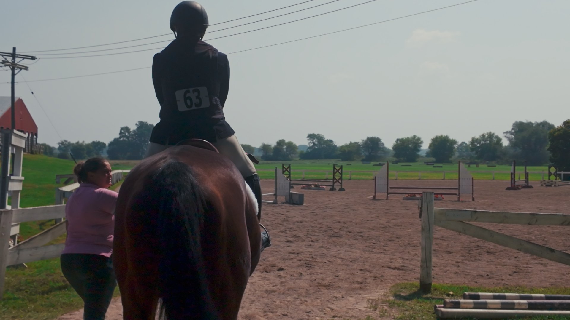 Wendy S. and Teresa M. enter the show arena on Max the horse