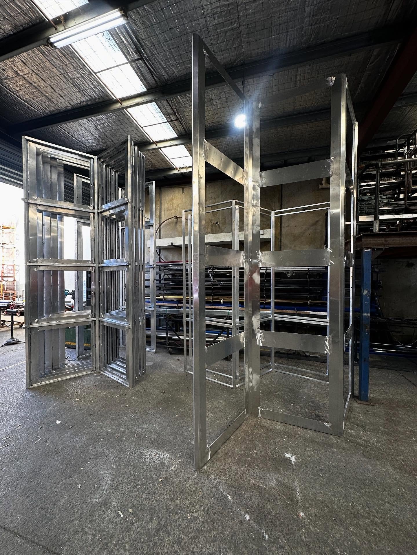 Ceiling feature frames standing tall! These 20 frames all connect to create a 17m x 8m ceiling feature, perspex panels and LED lighting will give it the final touch 💡#zelangasteel #madeinmelbourne🇦🇺 #metalwork #welding #aluminium #shopfitting #she