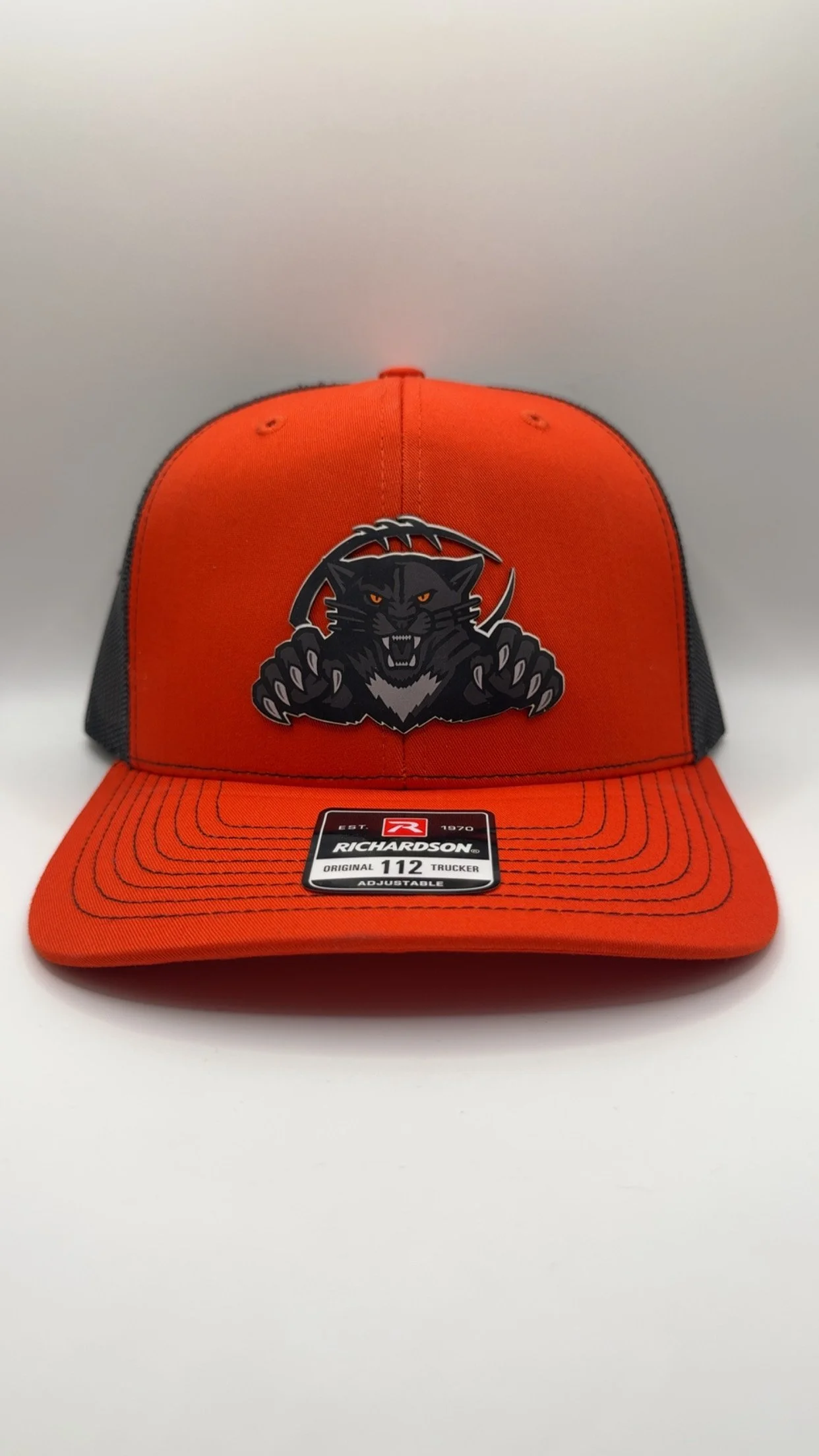 Orange and Black Trucker Hat with Black Logo with Football