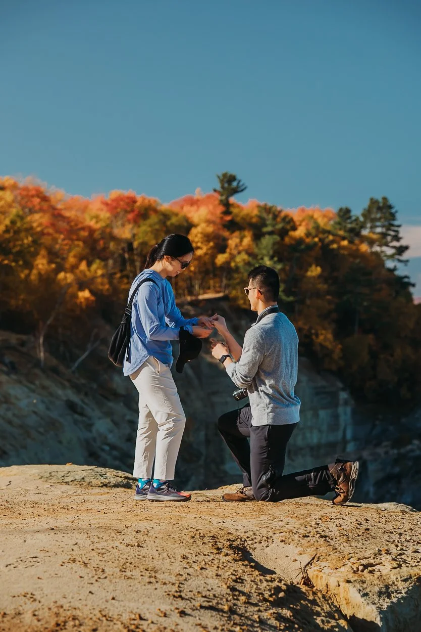 a marriage proposal at pictured rocks national lakeshore in munising michigan along the chapel rock mosquito falls loop trail.