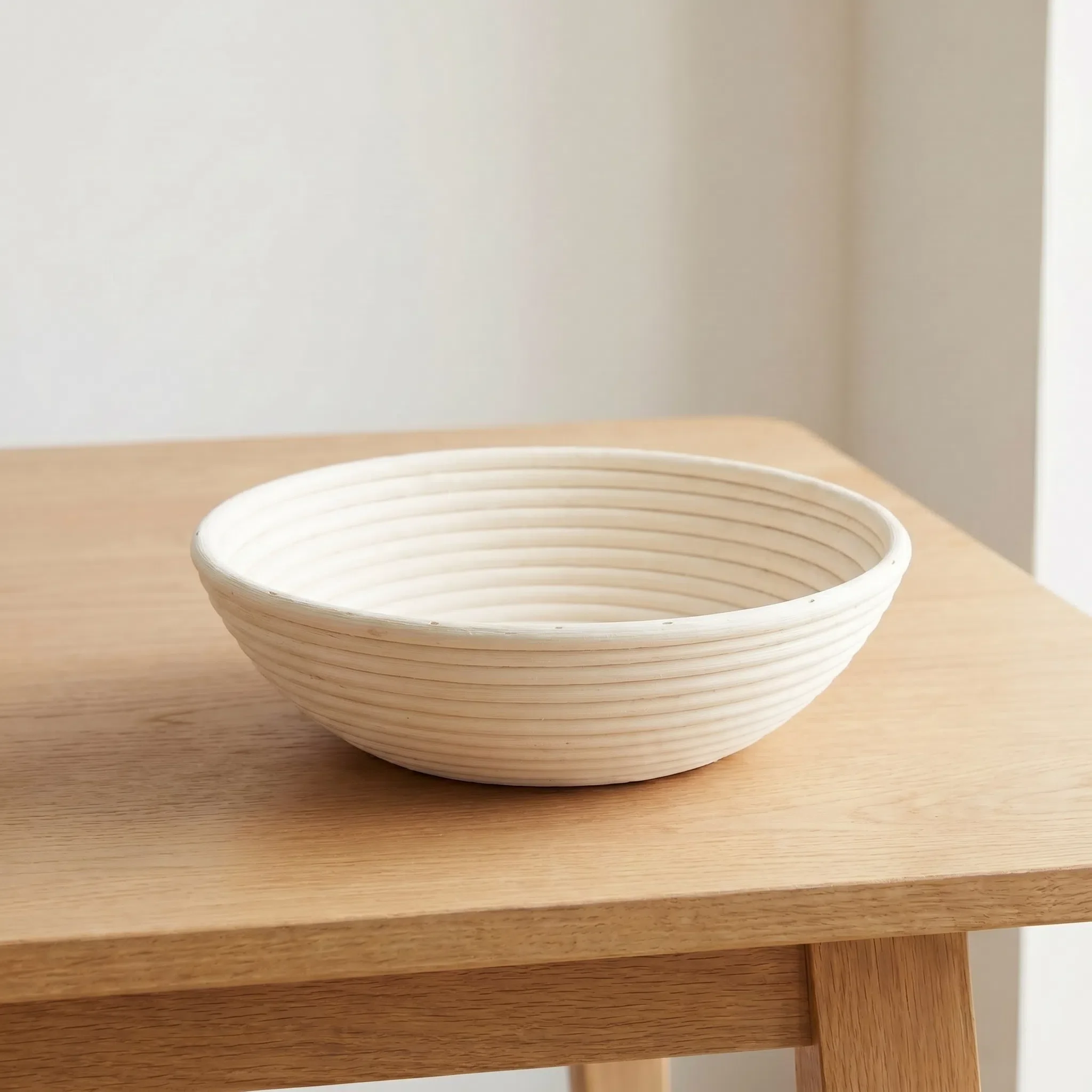 Large 12-inch round natural rattan bread proofing basket showing traditional spiral texture