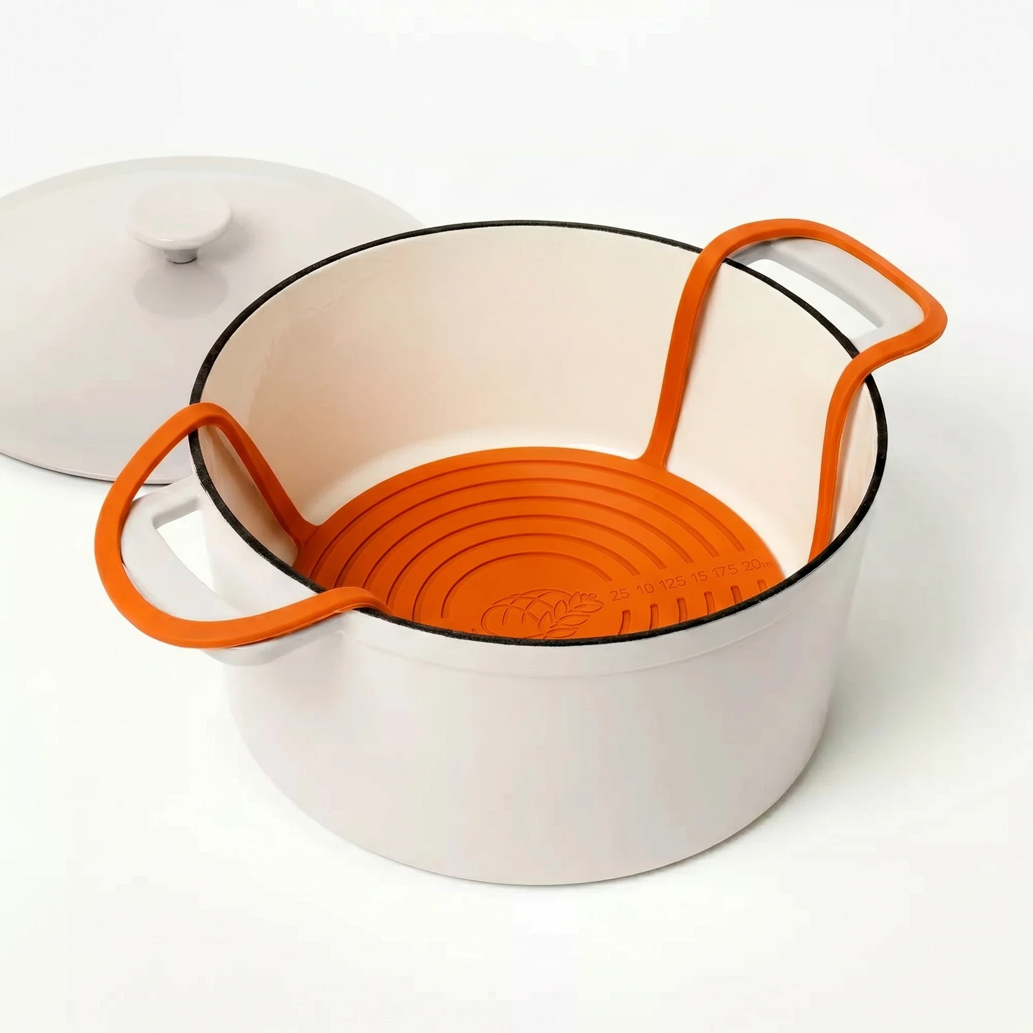 Orange round silicone bread sling for baking sourdough in a Dutch oven