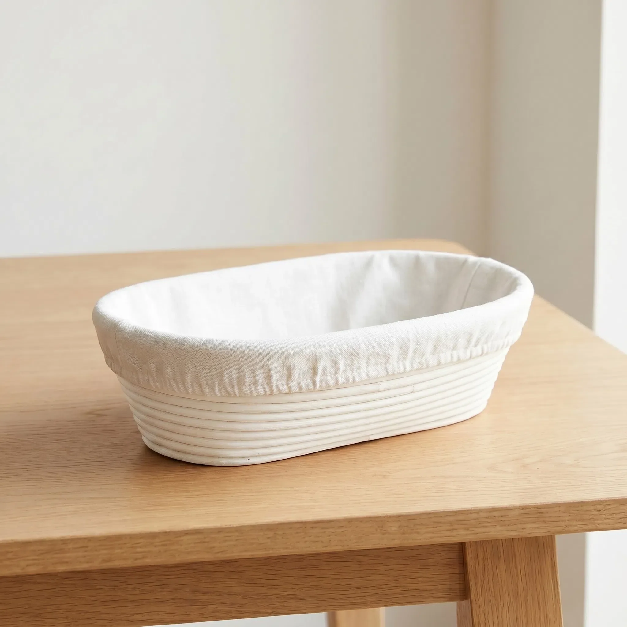 Large 12-inch oval natural rattan bread proofing basket showing traditional spiral texture