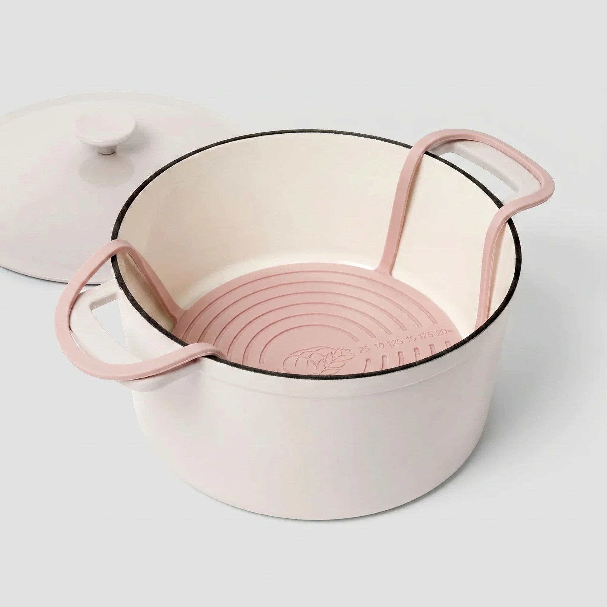 Pink round silicone bread sling for baking sourdough in a Dutch oven