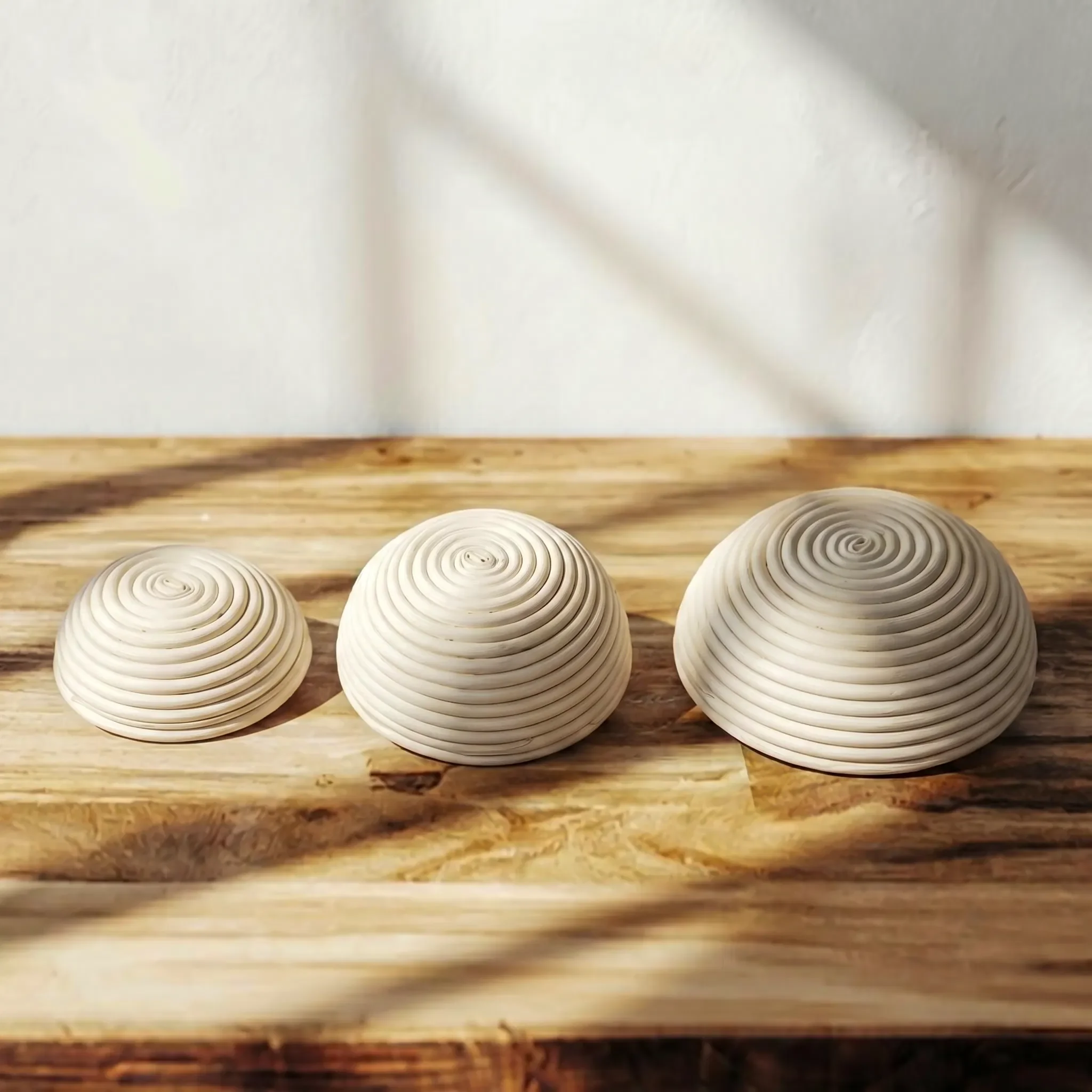 Round rattan proofing baskets shown in multiple sizes for comparison