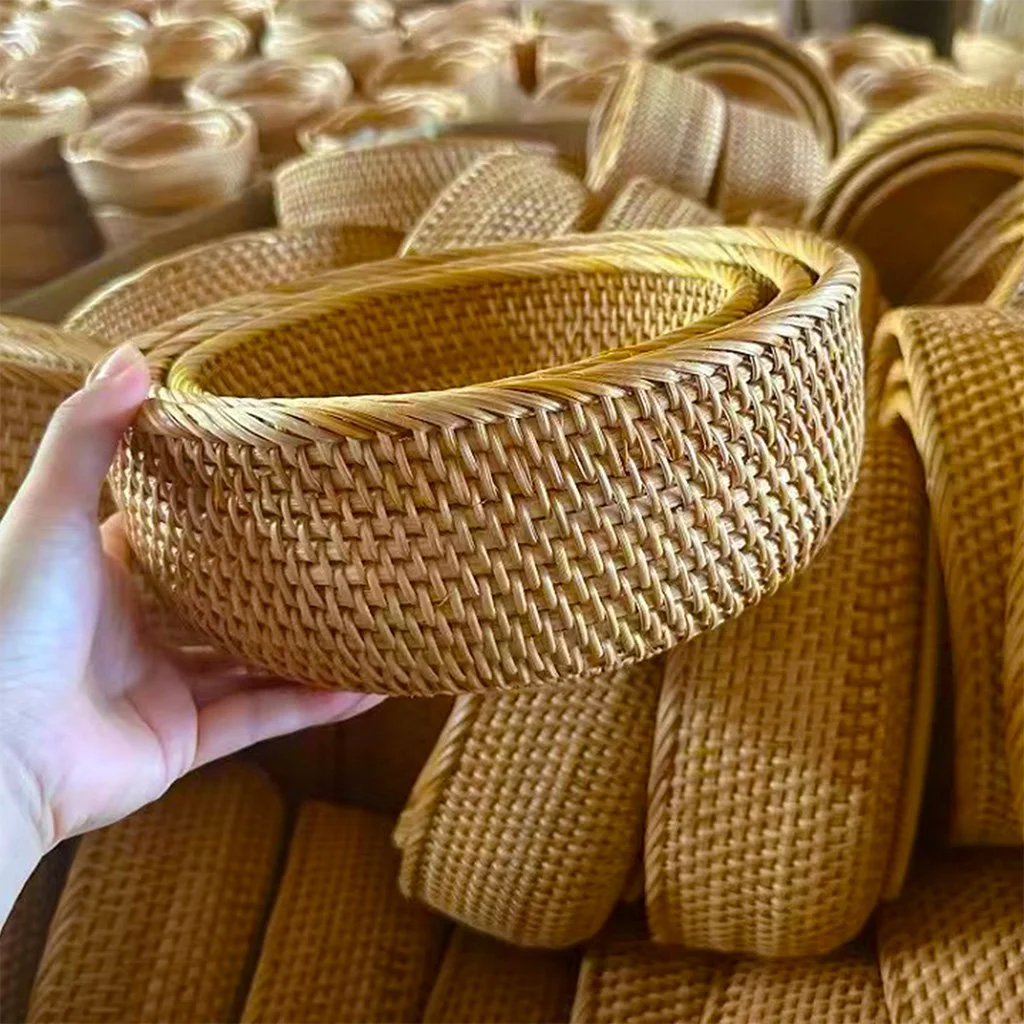 Skilled artisan weaving natural rattan by hand using traditional craftsmanship