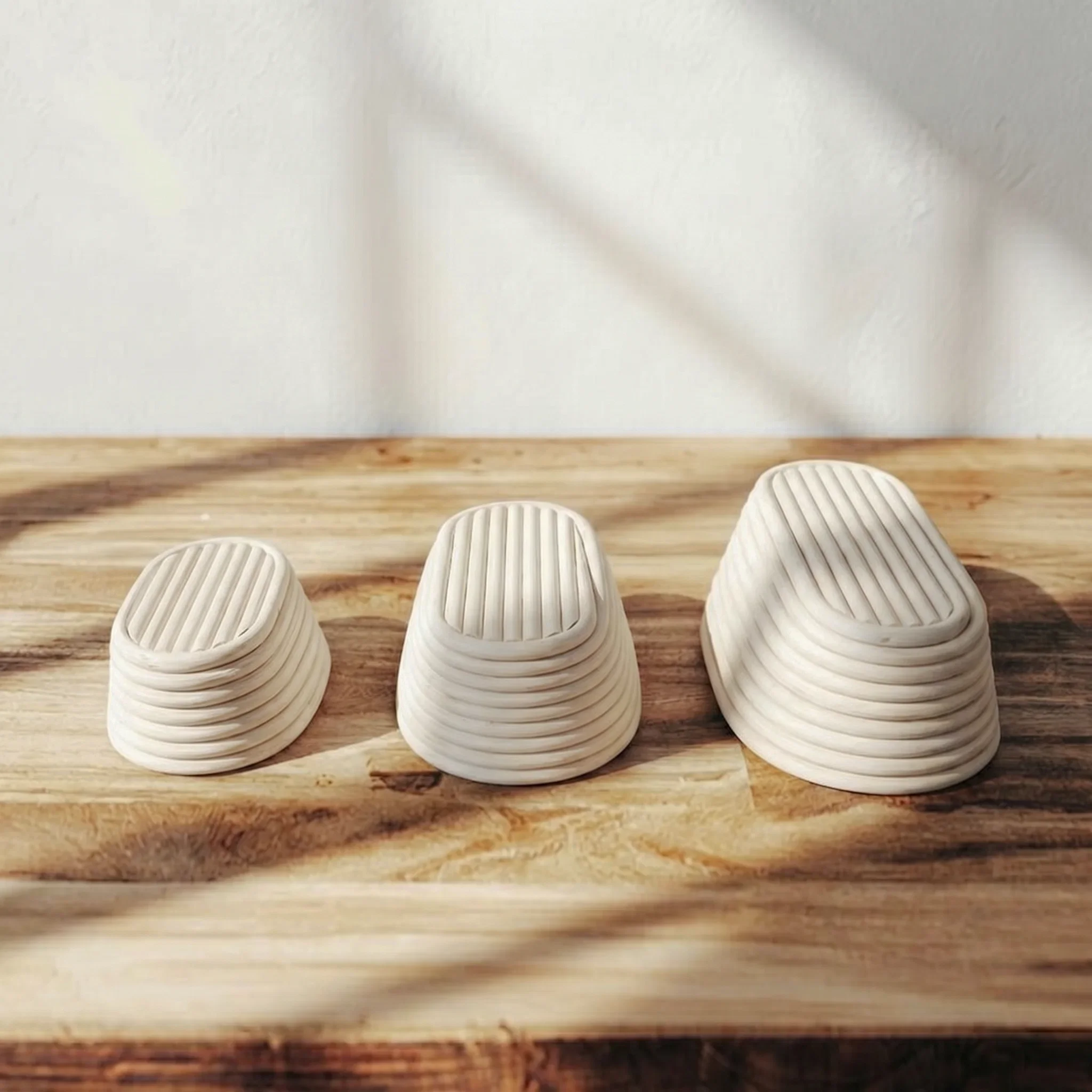 Set of 3 oval rattan proofing baskets shown with size reference