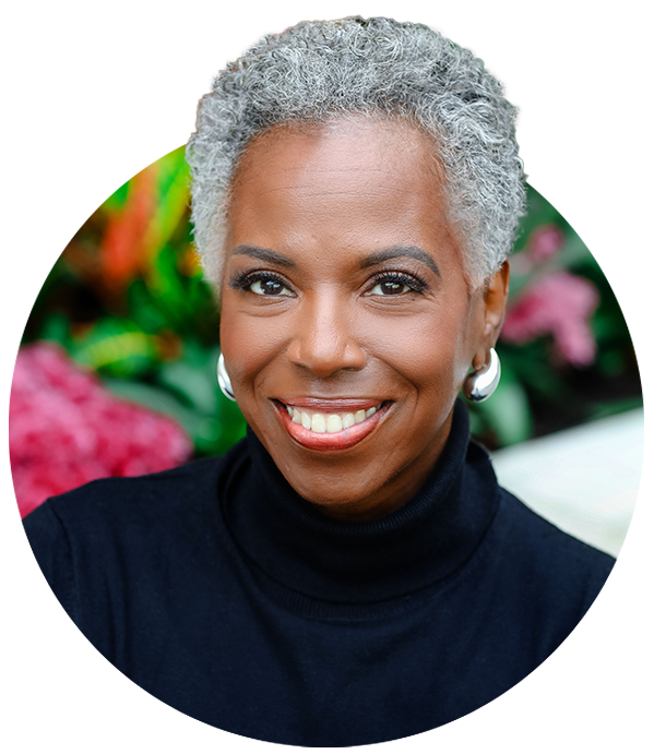 Founder Carmen Daniels Jones, an older woman with gray hair, dressed in a black turtleneck.