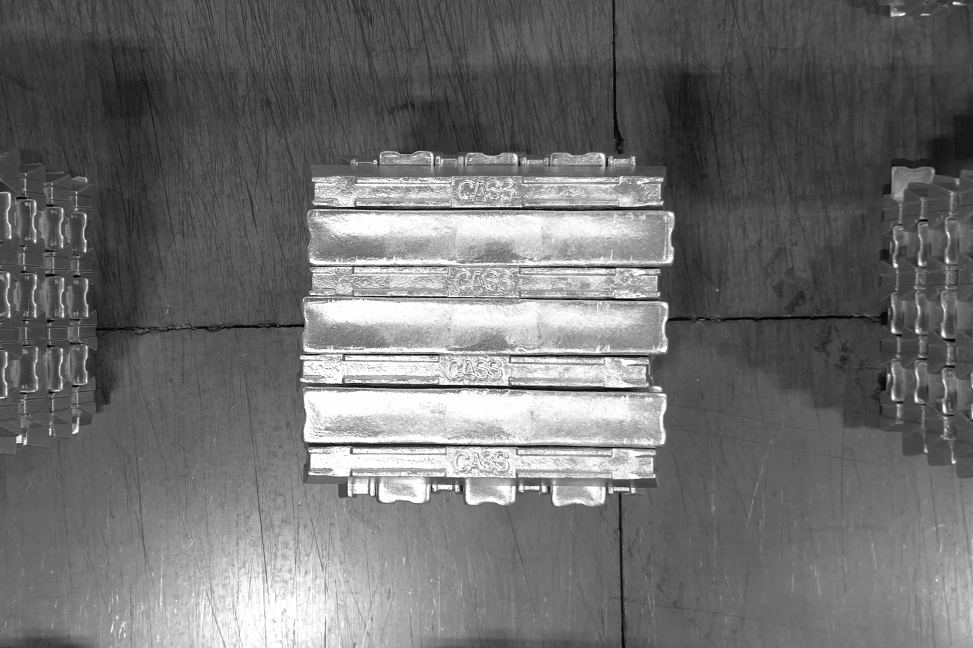 Stacks of aluminum ingots arranged in rows in a manufacturing or storage facility.