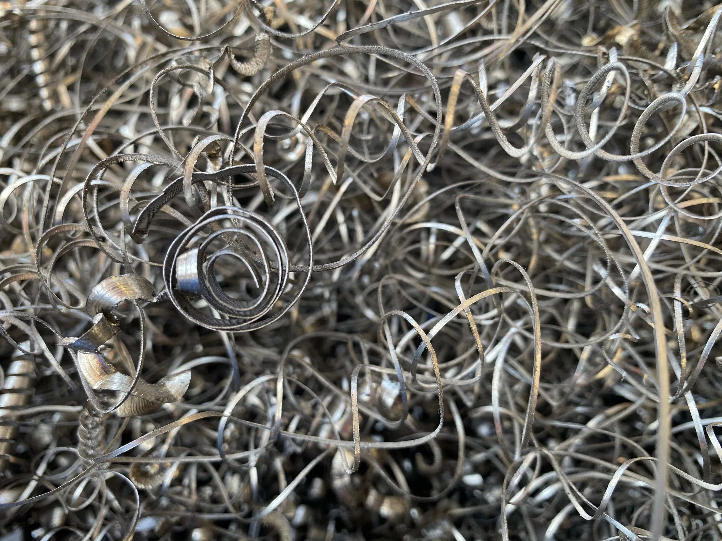 Close-up of tangled and curled metal shavings or scraps.