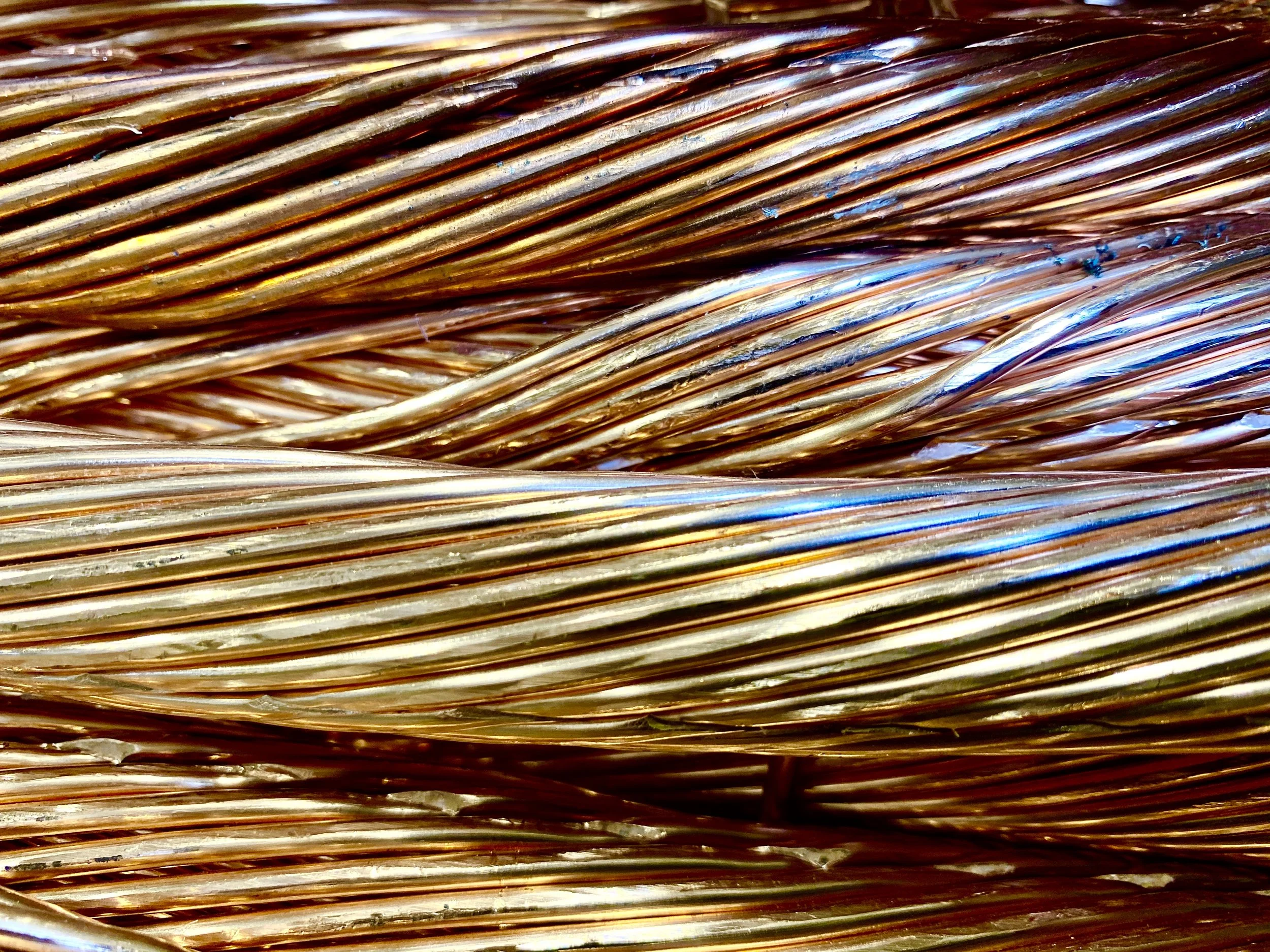 Close-up of intertwined copper wires or wires with a copper-like appearance.