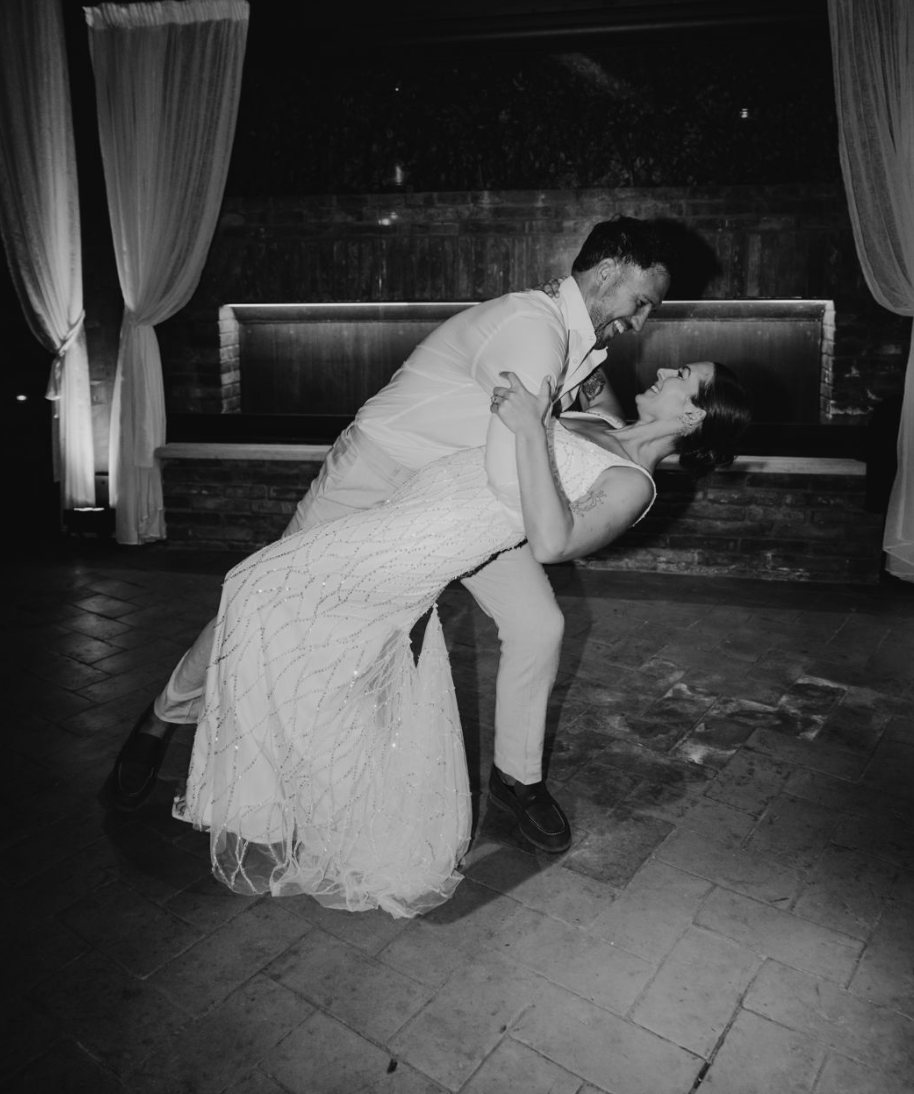 Bride and groom performing a romantic dip during their wedding first dance after lessons in Essex