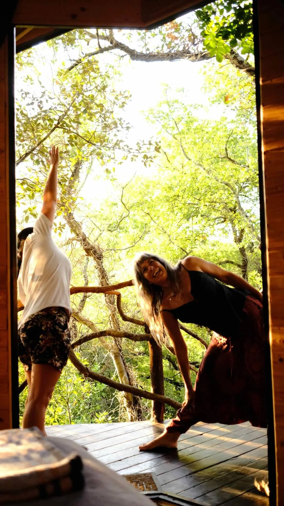 two women practising yoga in nature