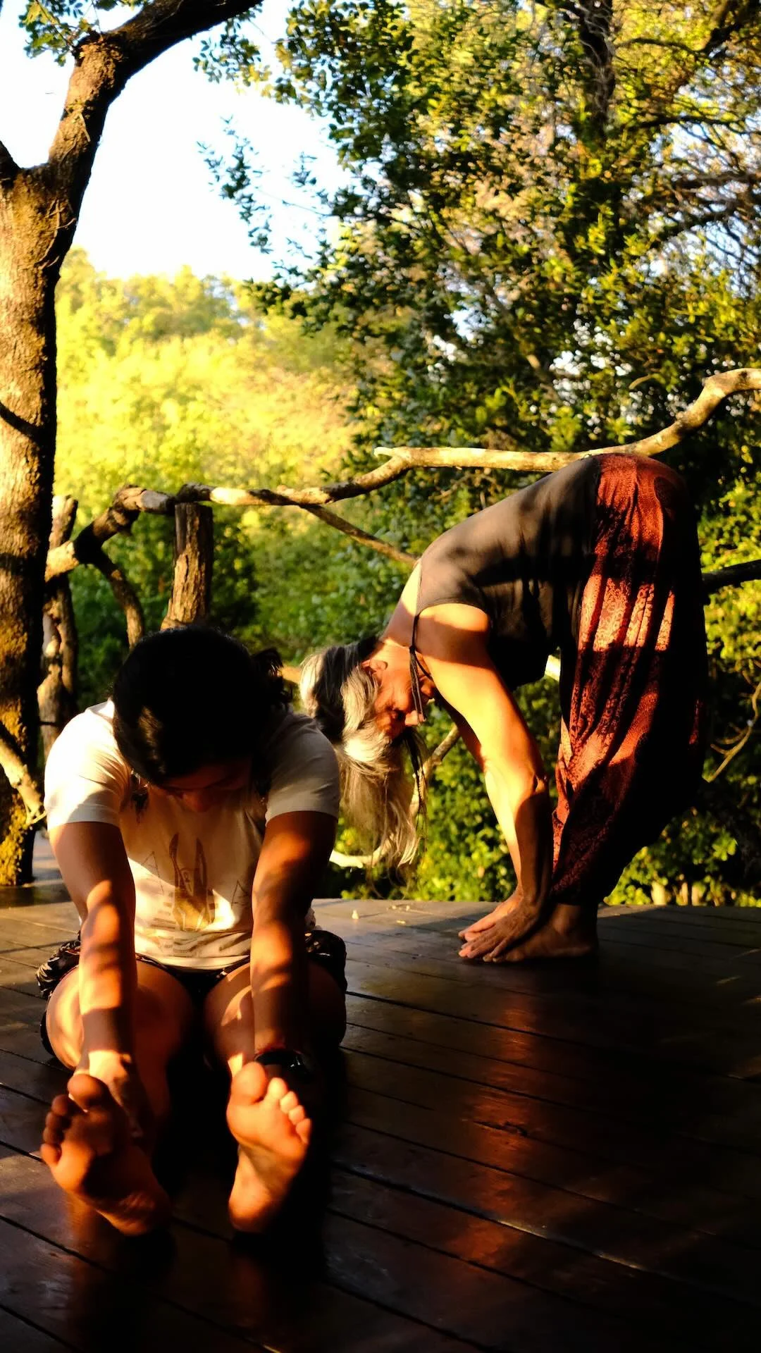 two women practicing trauma sensitive yoga