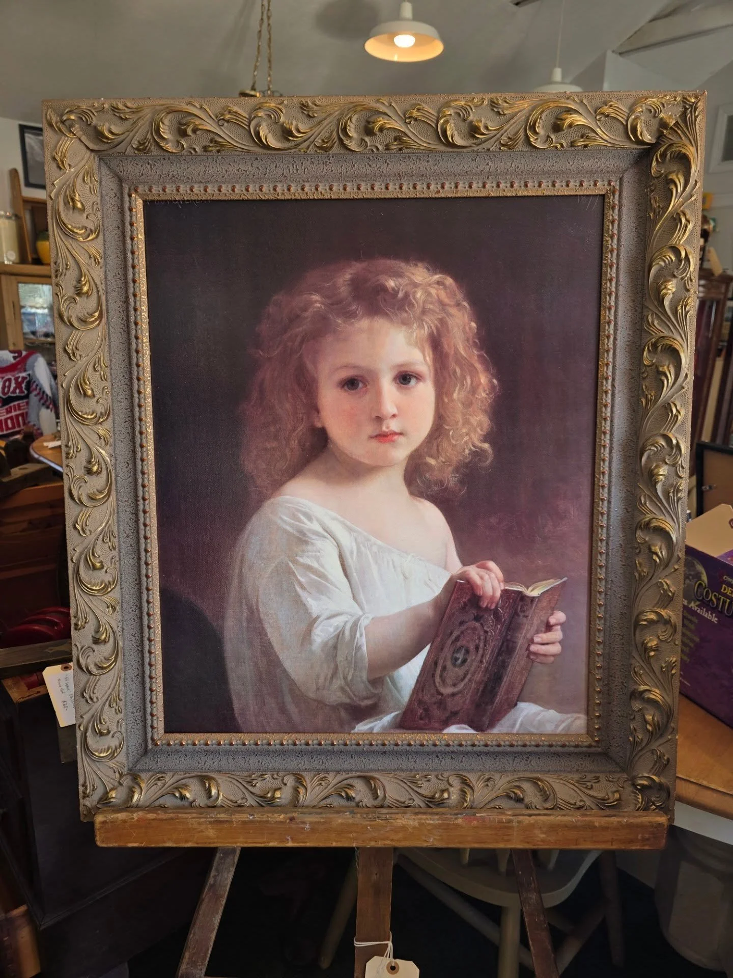Old-world charm, two ways ✨

1. Framed classical William-Adolohe Bouguereau &quot;Young Girl with Book&quot;  oil on canvas with an ornate, gilded frame,  Ready to hang and elevate any room.

2. Sturdy vintage wooden studio easel with wonderful patin