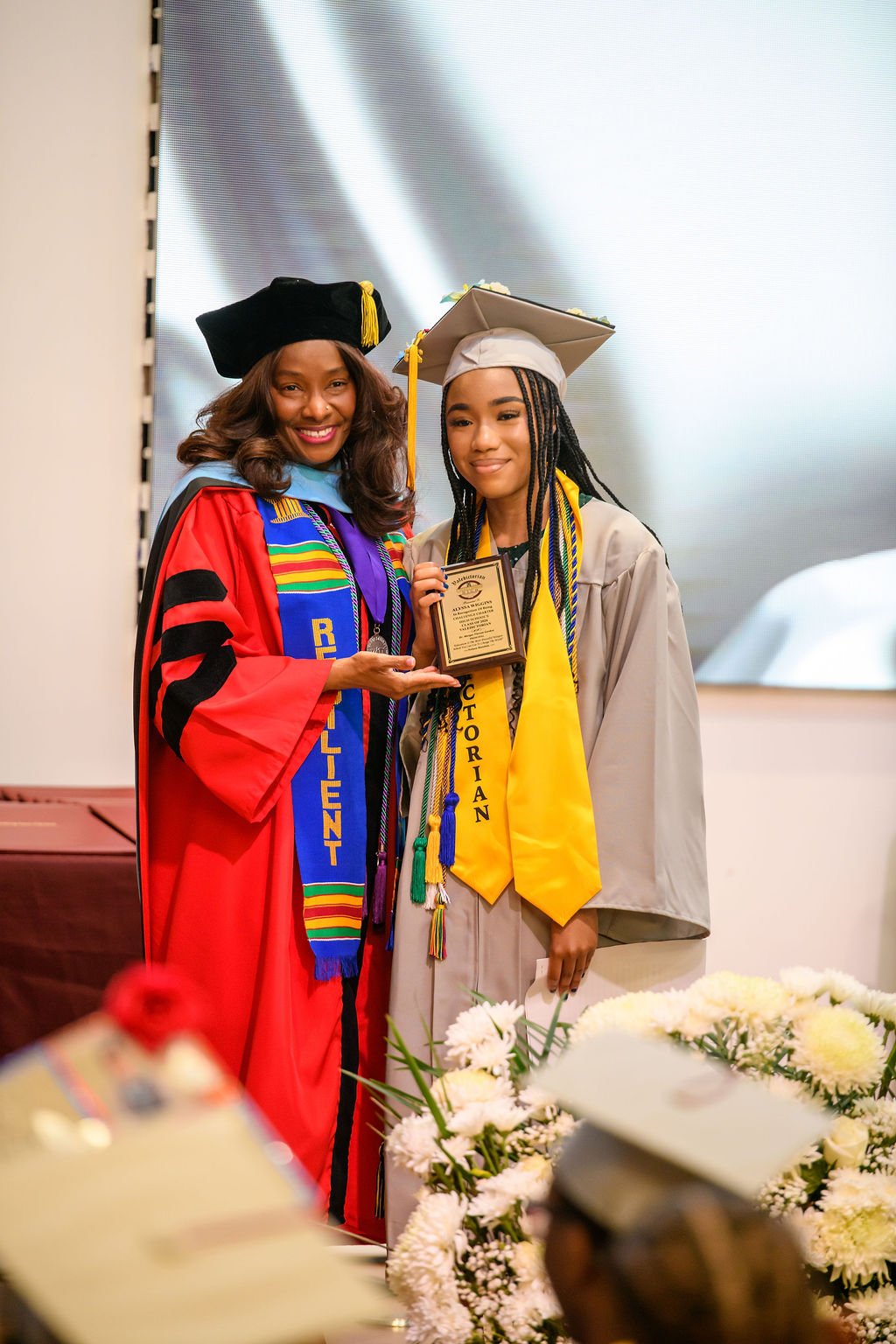 Dr. Gordon stands with Valedictorian on graduation day