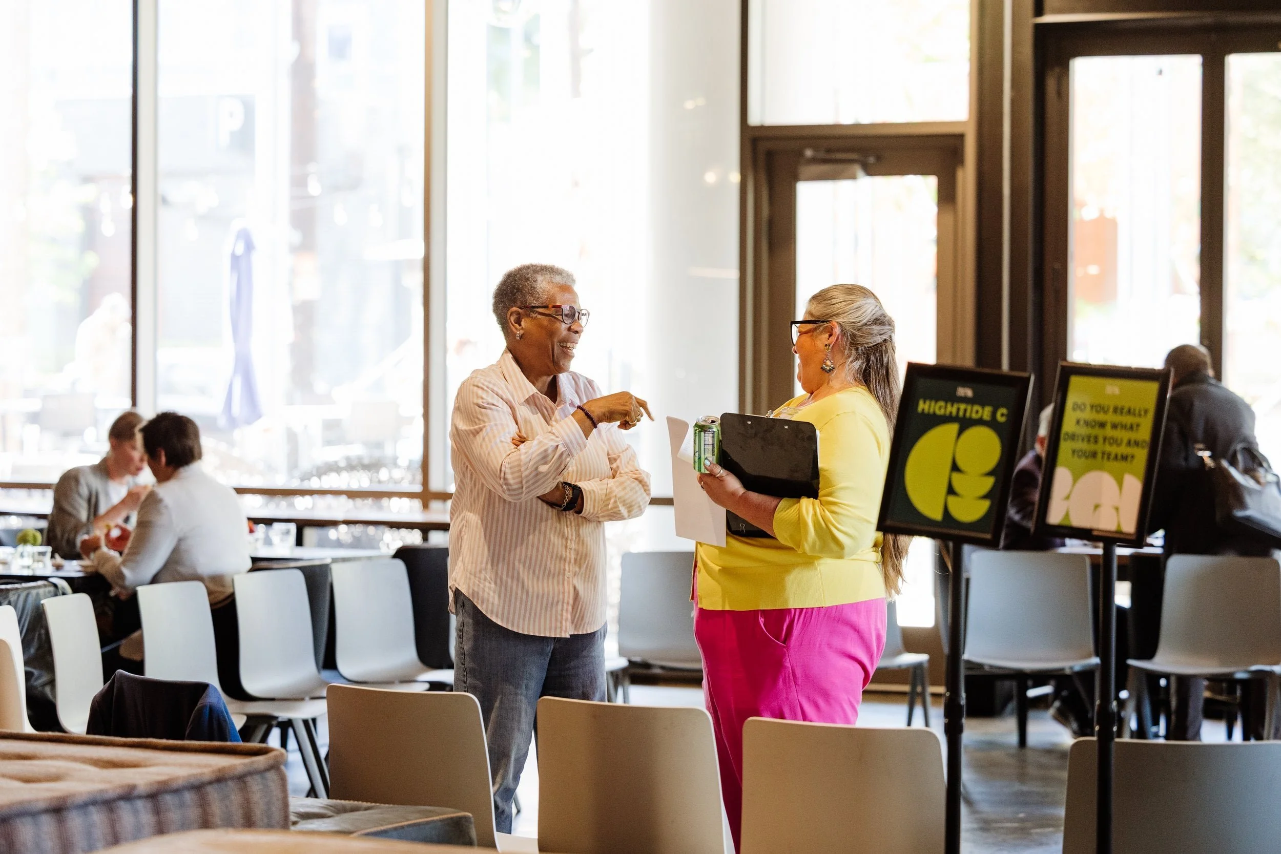 Two people converse at a business leadership conference for corporate executives in Seattle, Wa