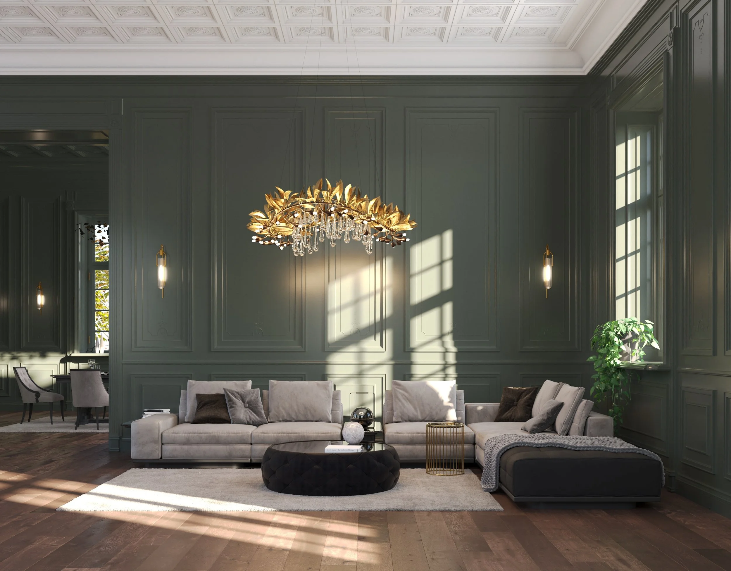 Spacious living room with gray paneled walls, large windows, a modern gold chandelier with leaf and droplet accents, a white sectional sofa with assorted pillows, a black leather ottoman, and decorative items including a plant and lamps, illuminated 