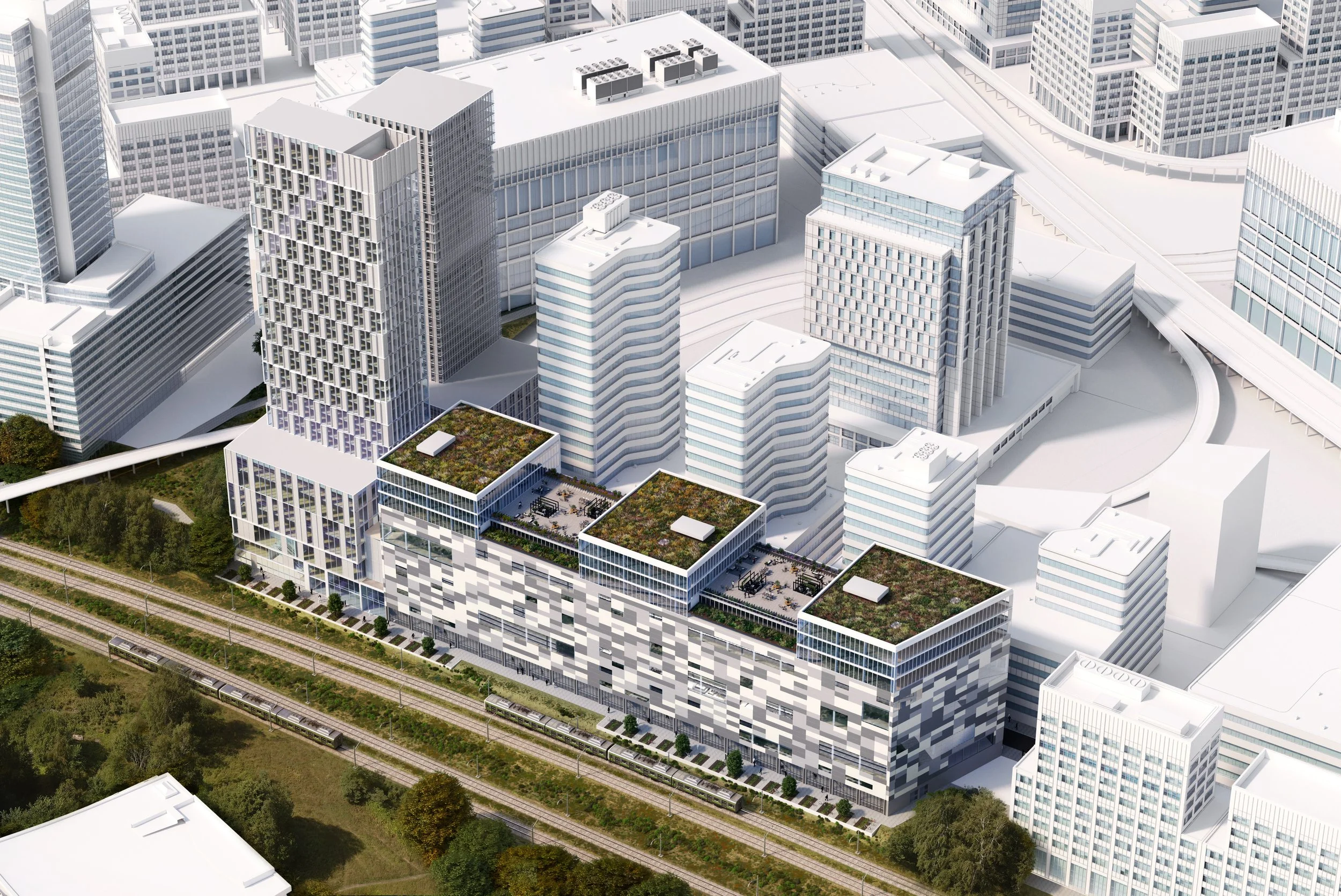 Aerial view of modern white skyscrapers and office buildings in a city with green areas and train tracks at the bottom.