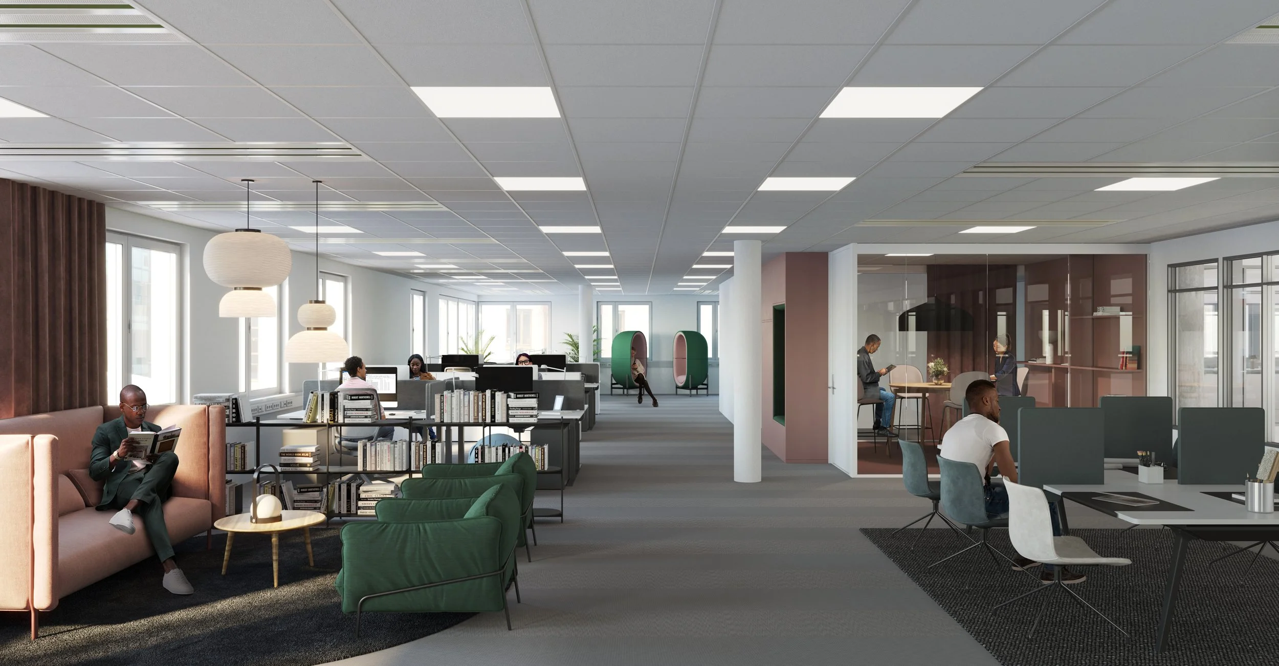 Modern office space with employees working at desks, reading, and talking, featuring large windows, hanging light fixtures, and a cozy seating area with green chairs and bookshelves.
