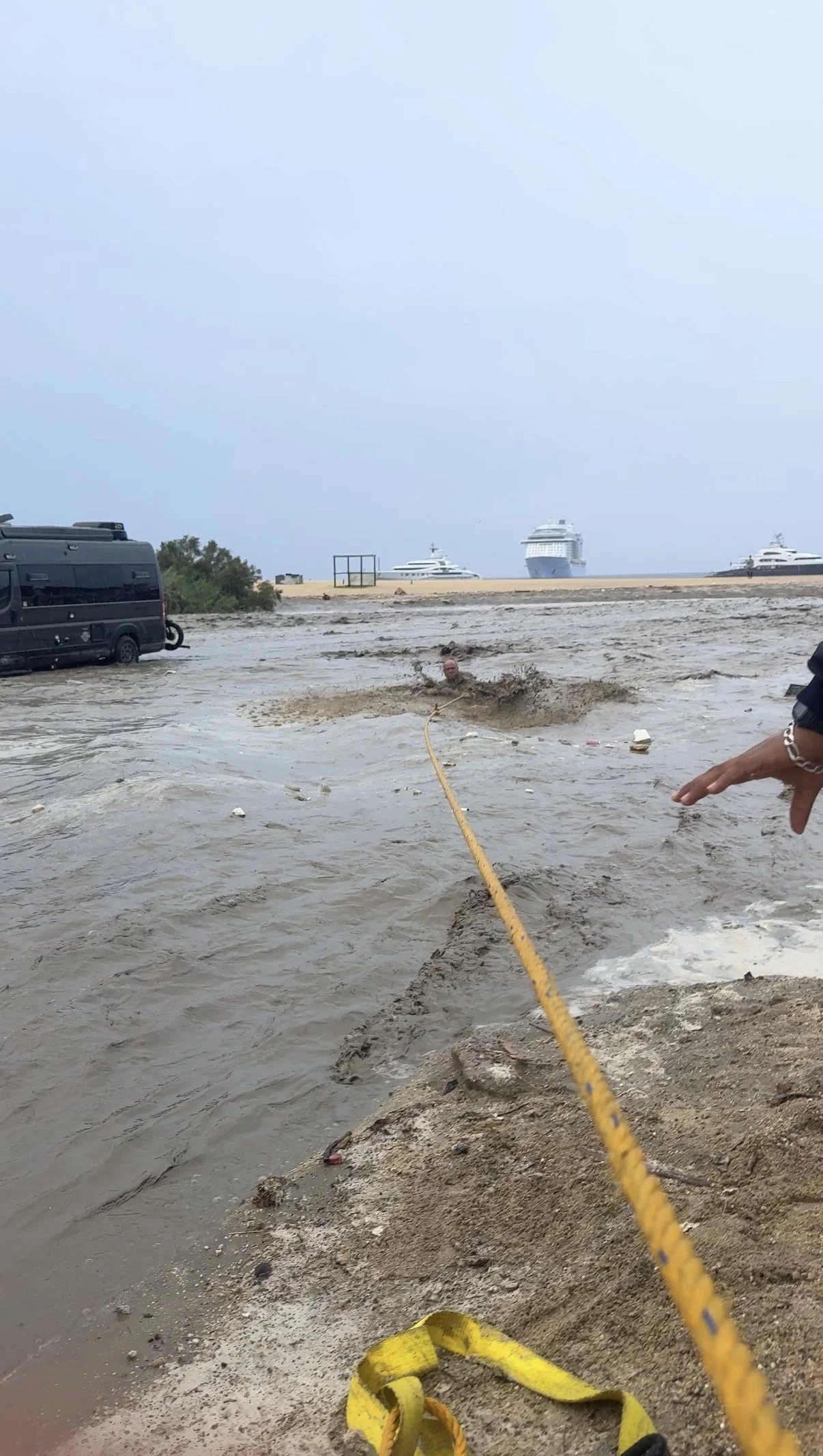 A yellow rope and a 4Runner acting as a lifeline for Paul in the middle of a Cabo flash flood.