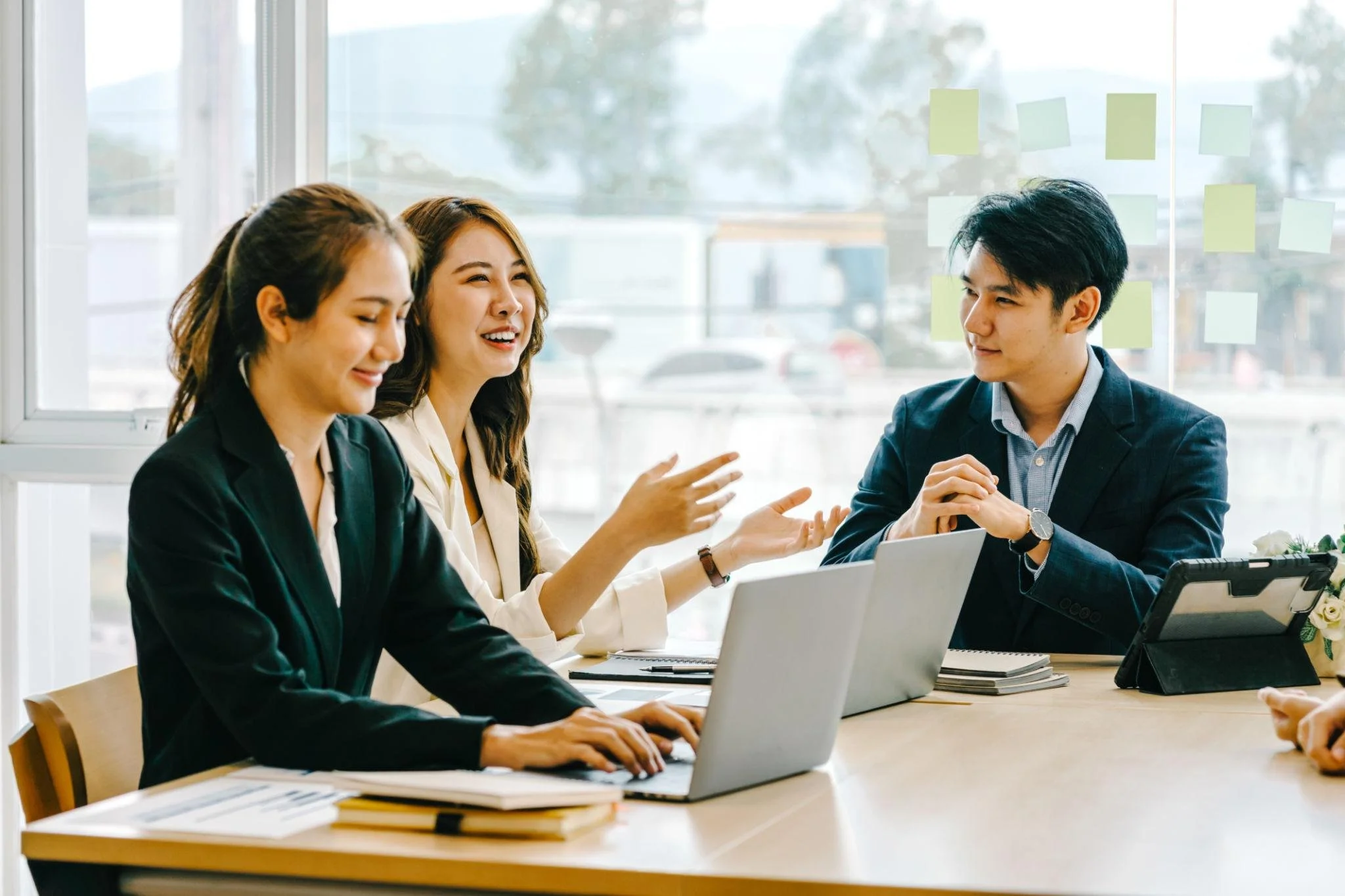 Filipino business professionals collaborating during a team meeting in a modern office.