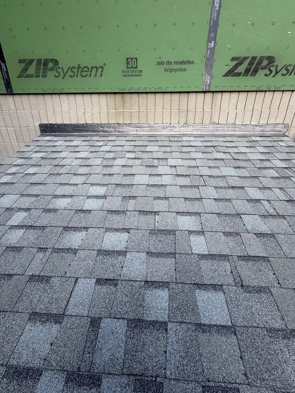 New lead headwall flashing and Cobblestone Gray shingles at the attached garage roof