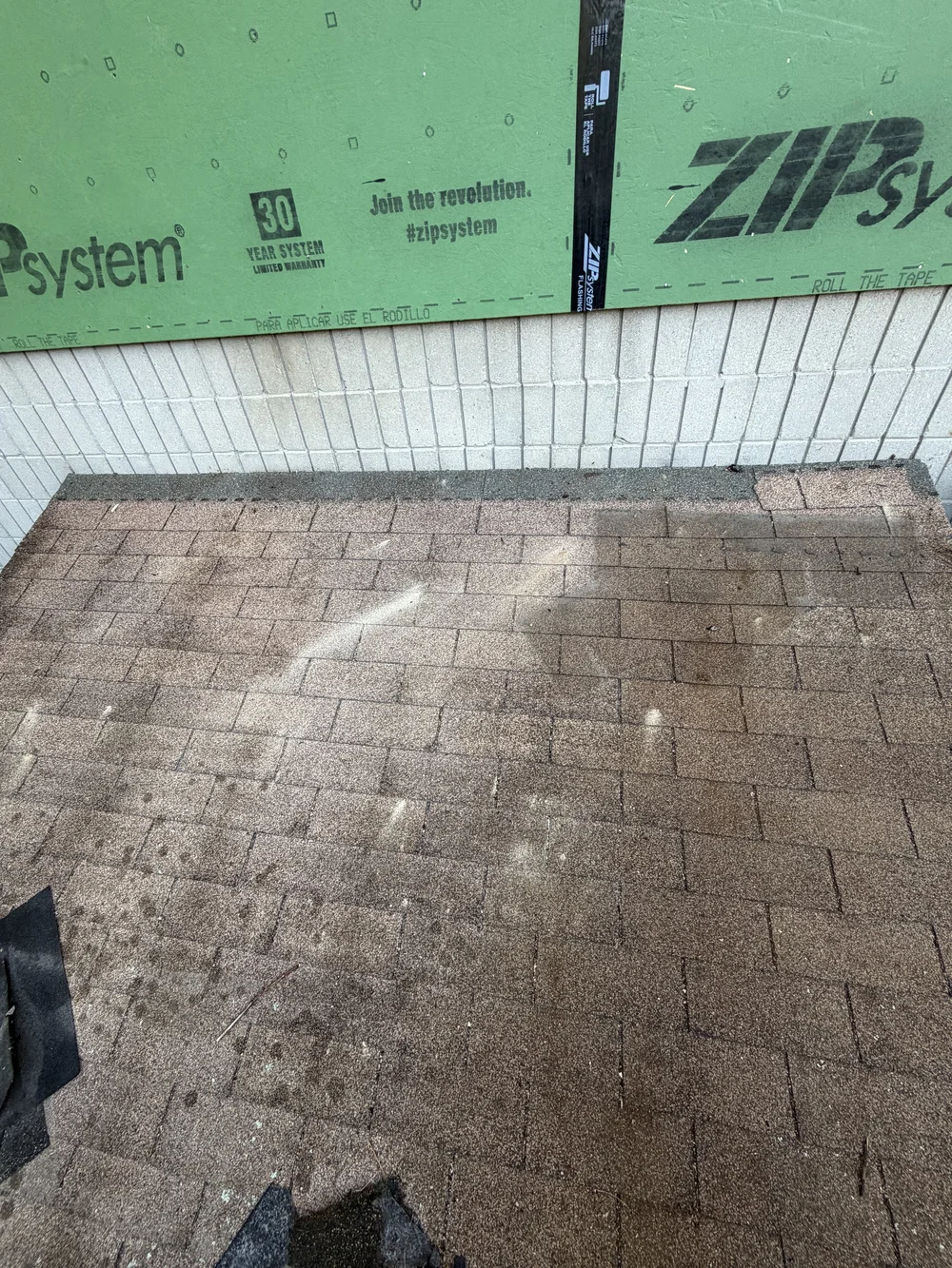 Original lean to roof connection without headwall flashing at the Dayton garage