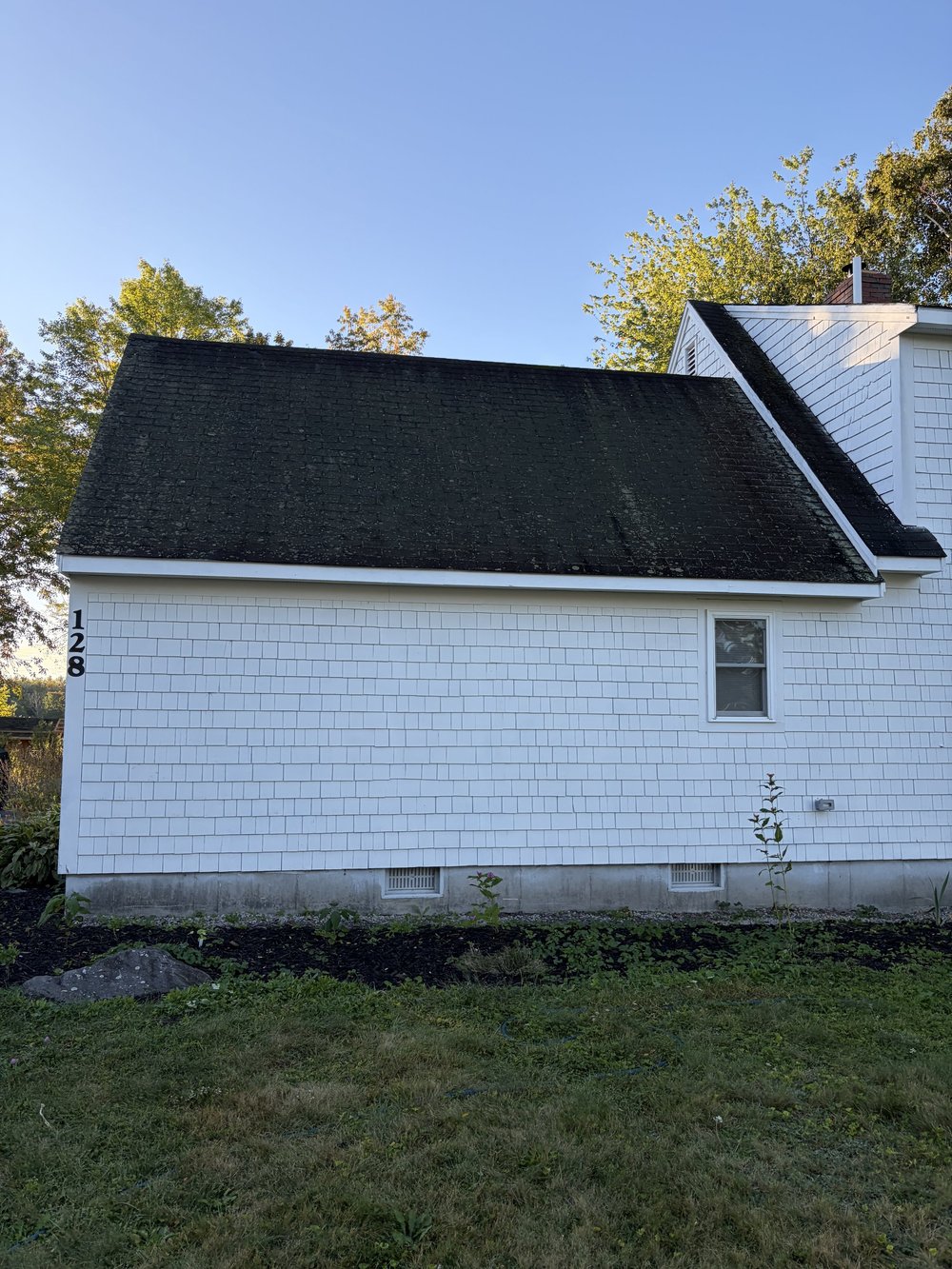Old shingle roofing on the rear section of the Lyman home before replacement