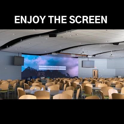 Conference room with a large LED screen showing a mountain landscape