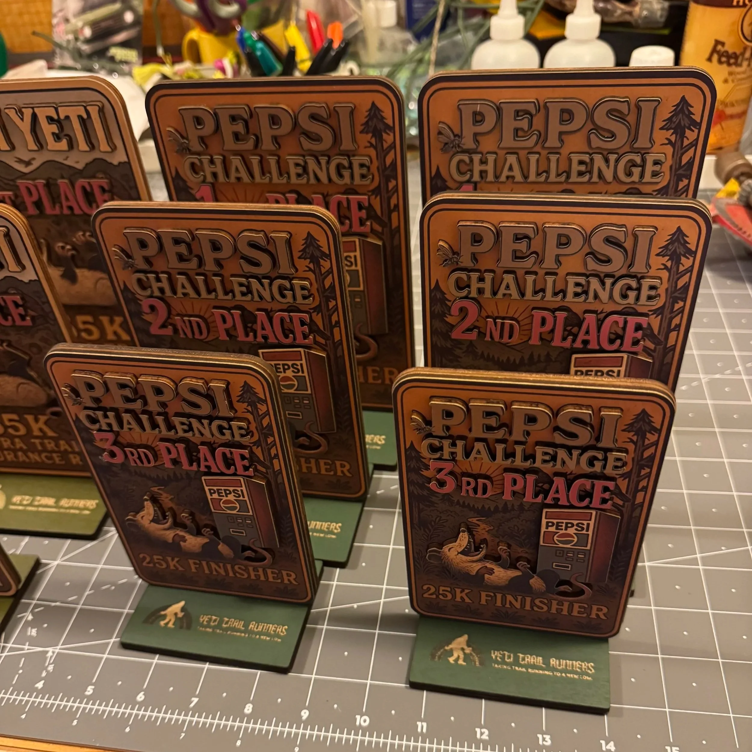 Trophies for the Pepsi Challenge race winners, showing 1st, 2nd, and 3rd place, with a mountain landscape and bears on the design.