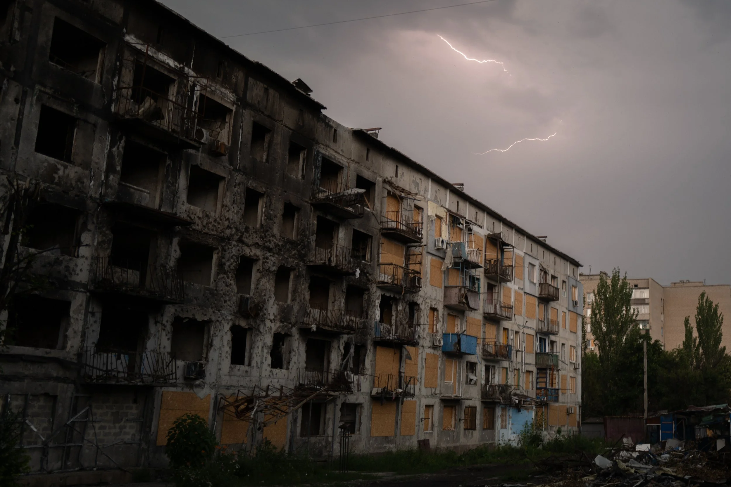 “A residential building damaged by a russian strike, photographed during a thunderstorm” by Kseniia Tomchyk
