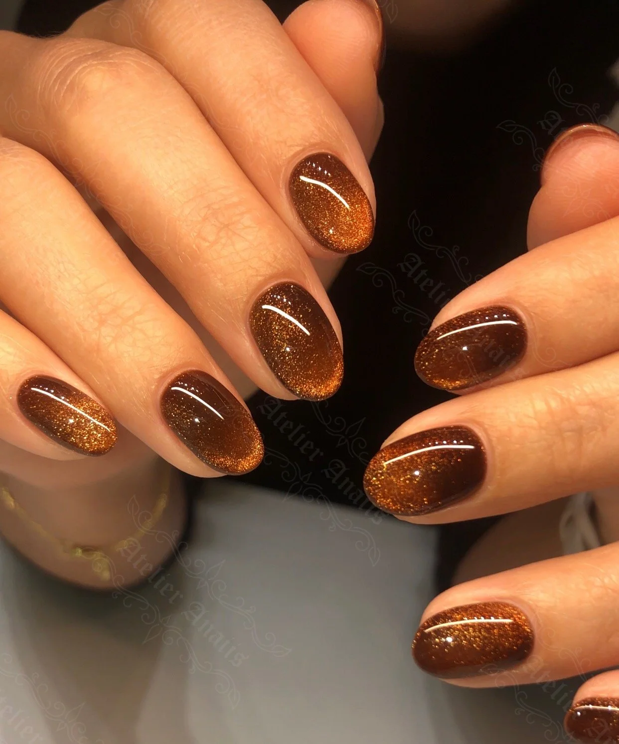 Medium nails with coffee brown cat-eye velvet polish.